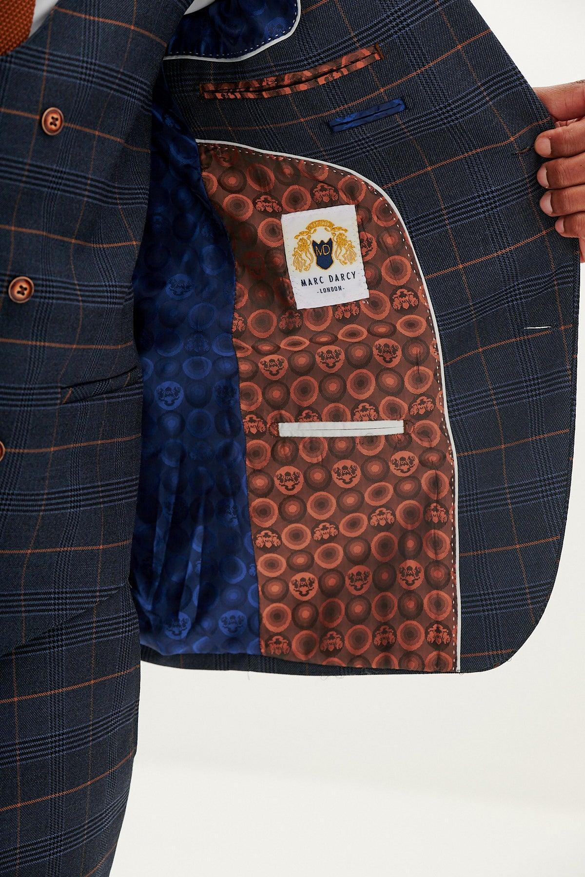 A person opens a marcdarcy JENSON - Marine Navy Check Blazer, revealing its blue and brown skull-patterned inner lining with a marcdarcy label—perfect for wearing as a smart wedding suit.