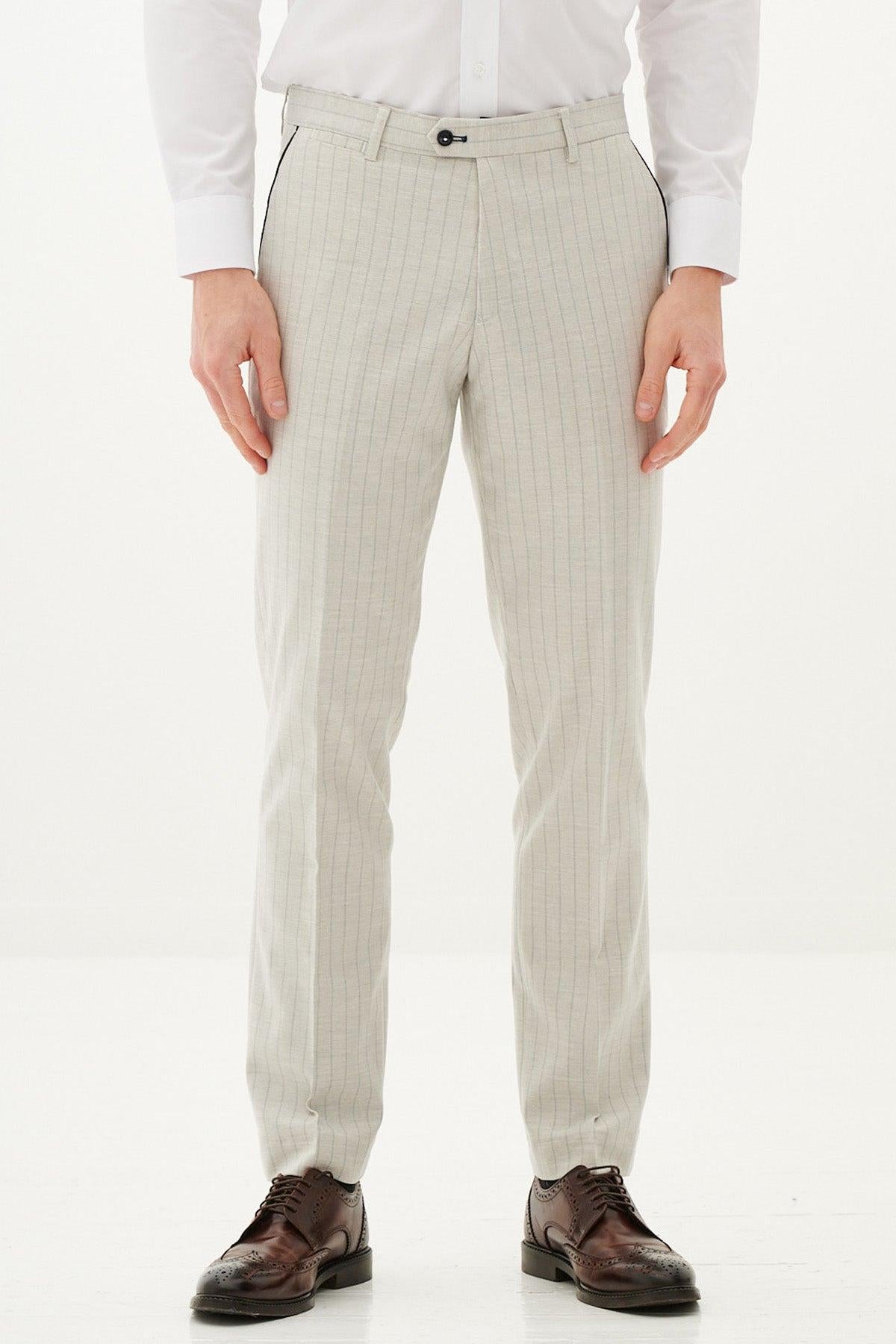 Close-up of a man wearing the Marc Darcy GRANT Stone Pinstripe Two Piece Suit and brown wingtip shoes.
