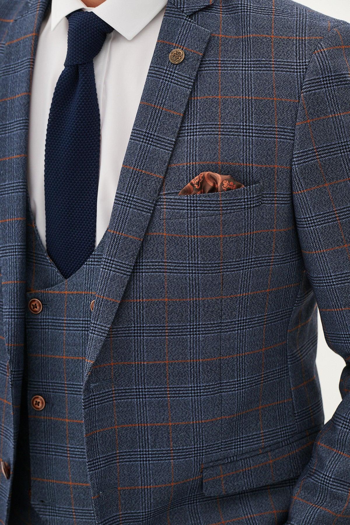 A person wearing the marcdarcy JENSON Sky Blue Check Suit with Double Breasted Waistcoat, white shirt, dark blue textured tie, and brown pocket square. The image is cropped at the neck and waist.