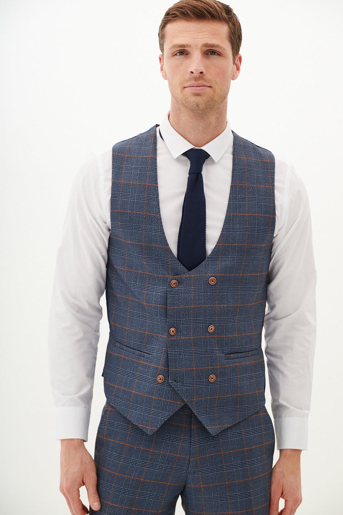 A man wearing a white dress shirt, dark tie, and a marcdarcy JENSON Sky Blue Check Double Breasted Waistcoat stands facing the camera against a plain white background.