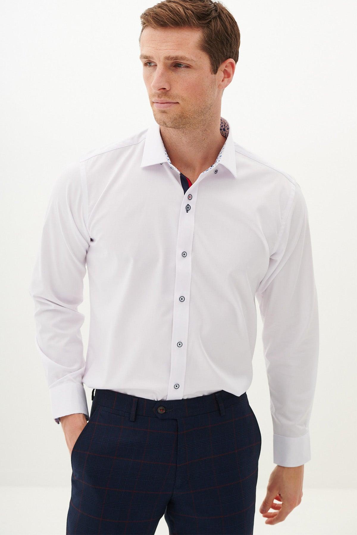 A man poses in office wear—a Marc Darcy LUKE white long sleeve shirt paired with navy plaid pants.