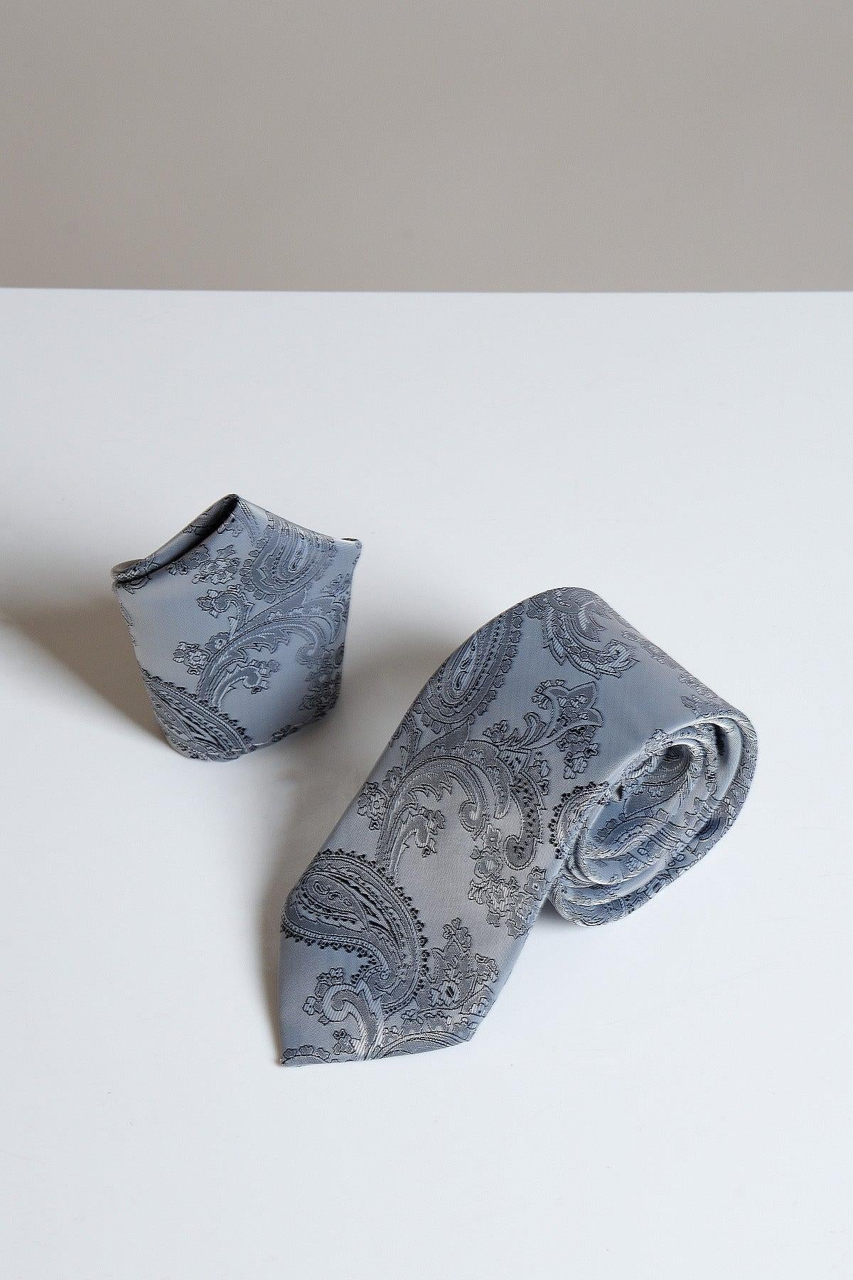 The Accessory MD PAISLEY Grey Paisley Tie and Pocket Square Set is displayed on a white surface against a neutral background, offering modern style with matching accessories.