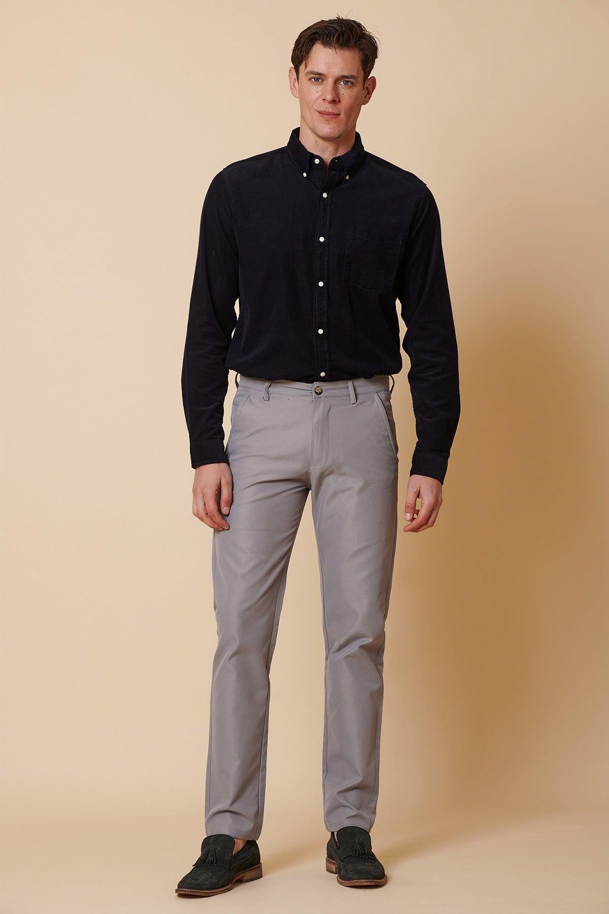 A man stands facing forward wearing a dark navy corduroy button-down shirt paired with marcdarcy's ENZO - Mid Grey Chinos.