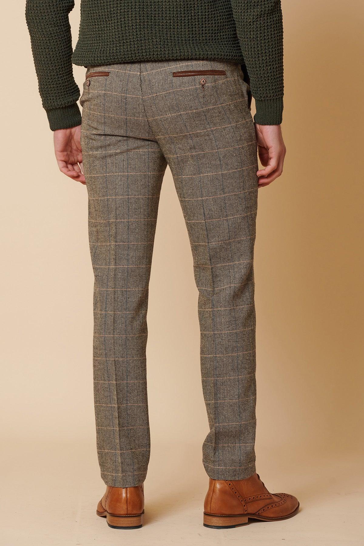 A person stands facing away, wearing the marcdarcy DX7 - Tan Tweed Check Two Piece Suit against a beige background.