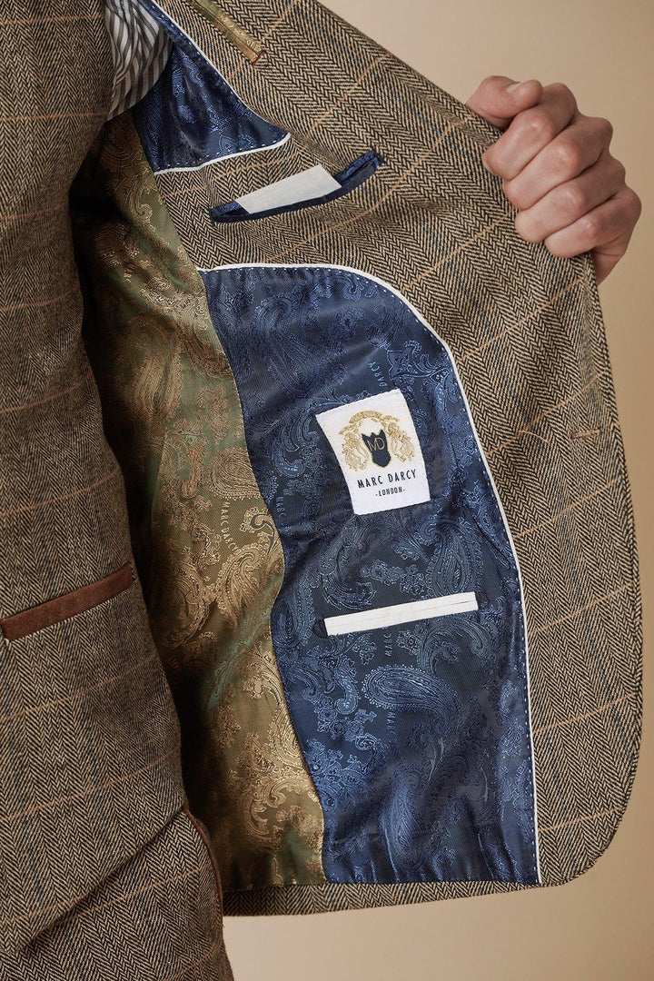 Someone holds open a tan tweed check blazer, revealing an inner lining with blue and gold paisley patterns and a white label that reads Marc Darcy, from the TED - Tan Tweed Check Two Piece Suit collection.