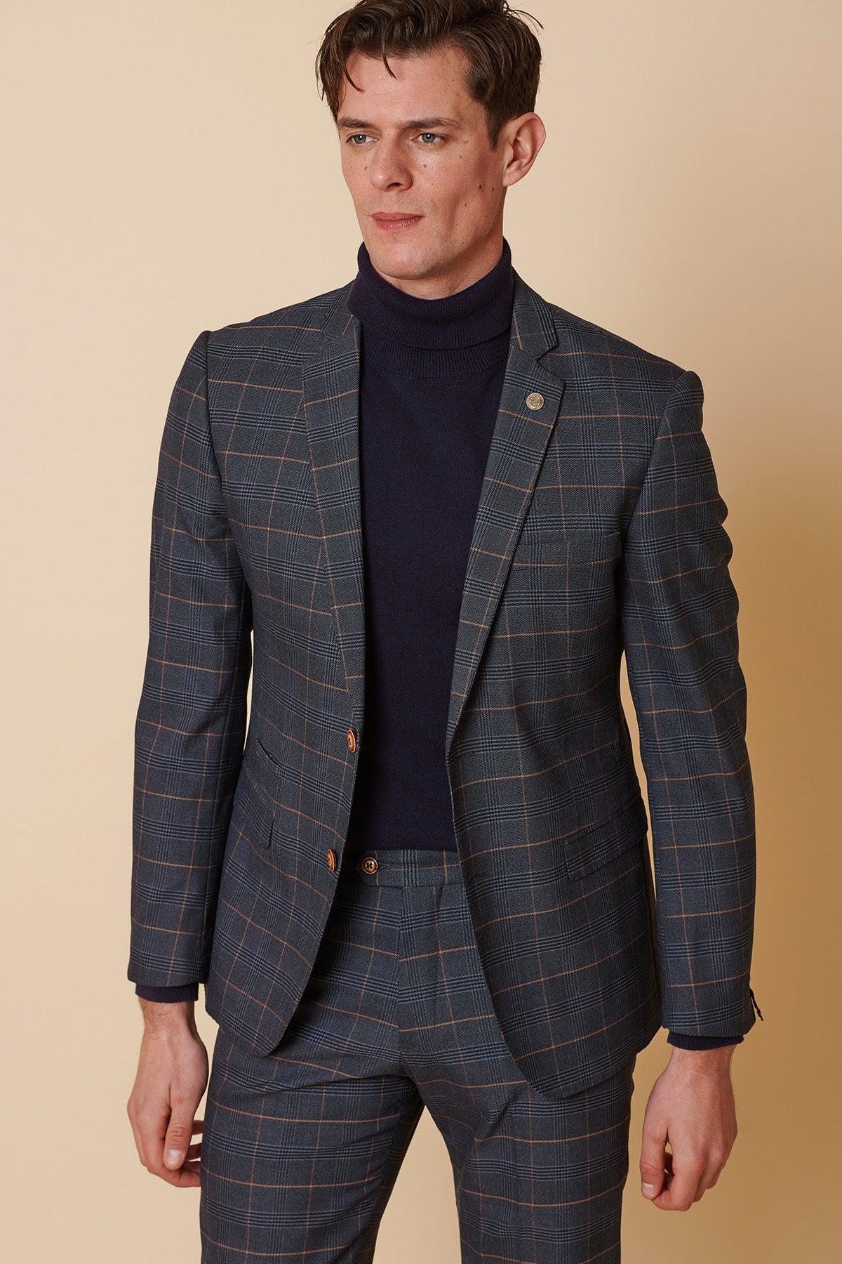 A man wears the Marc Darcy JENSON Marine Navy Check Two Piece Suit paired with a navy turtleneck.