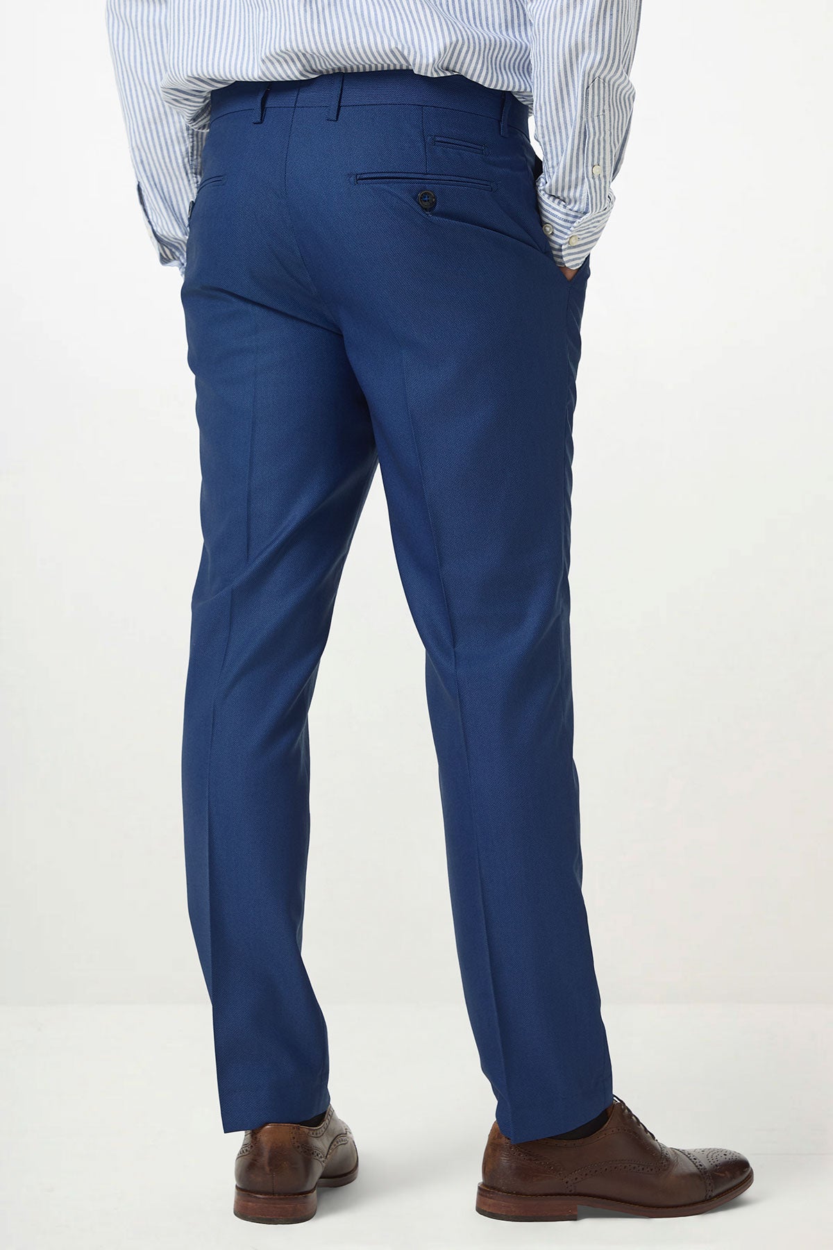 A person models the Marc Darcy DANNY Royal Blue Three Piece Suit with a single-breasted waistcoat, standing hands-in-pockets and facing away to showcase timeless workwear style.