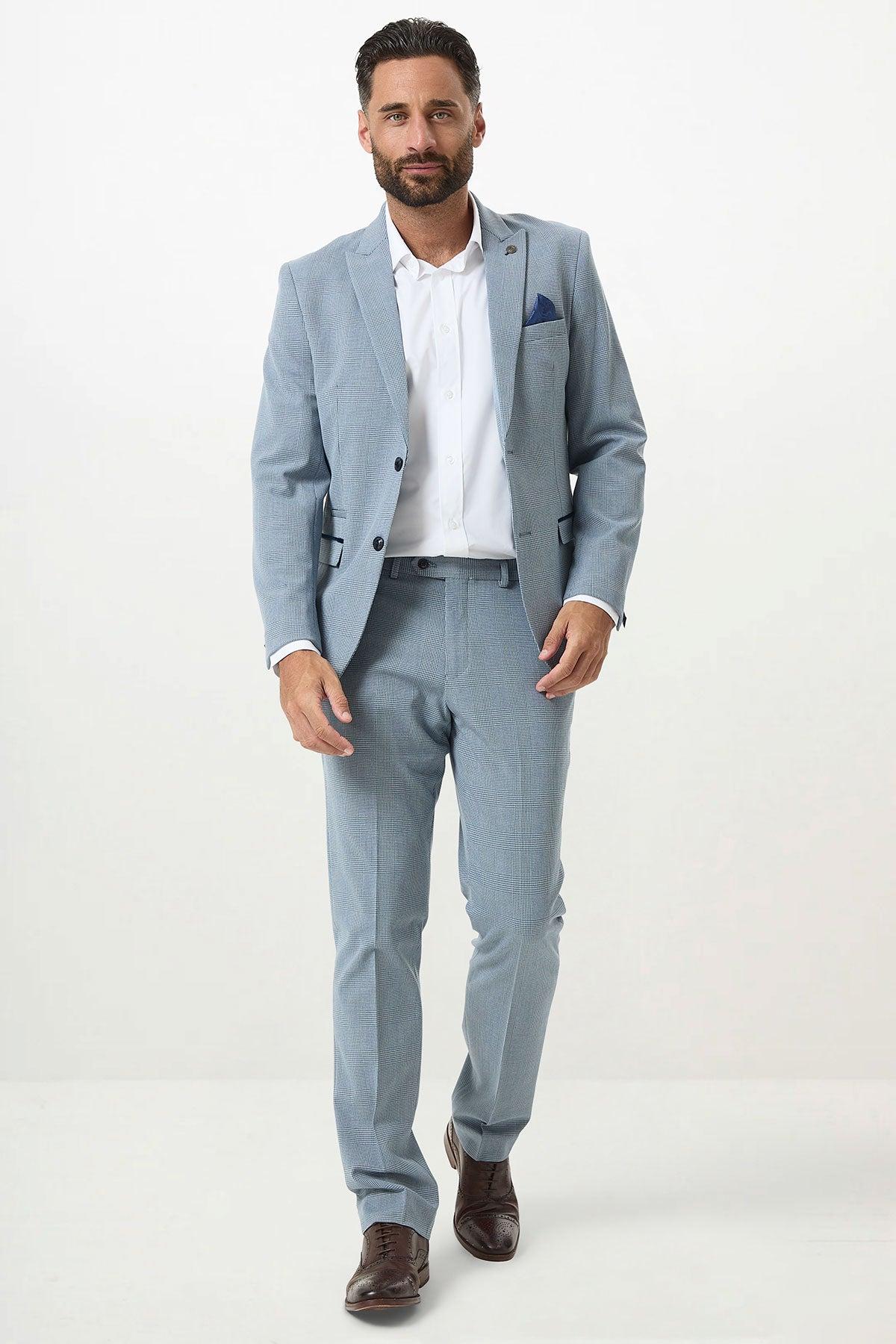 Man in a Marc Darcy BROMLEY Sky Blue Check Two Piece Suit, white shirt, brown shoes, and a crisp blue pocket square.
