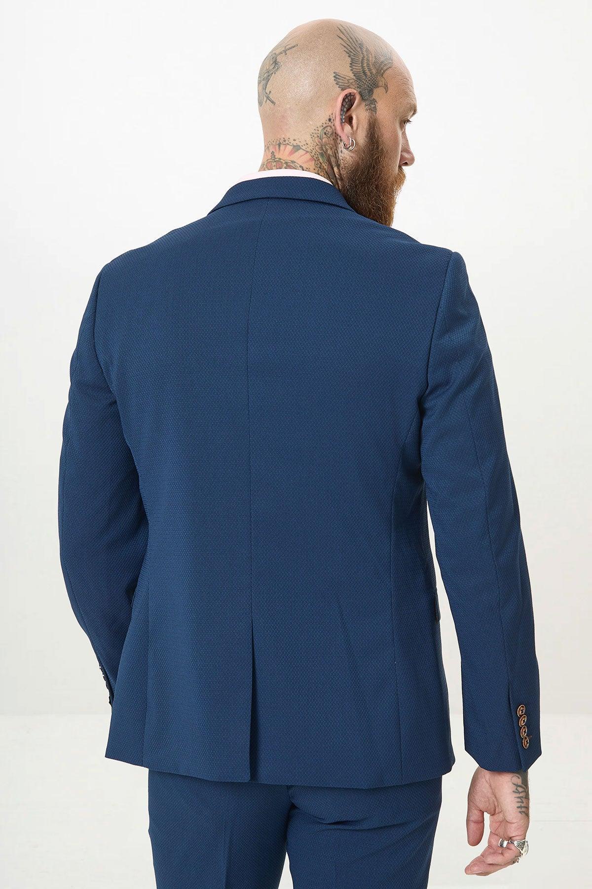 Man wearing the marcdarcy MAX - Royal Blue Blazer with Contrast Buttons, seen from the back. His head and neck tattoos lend a modern edge to this classic office look.