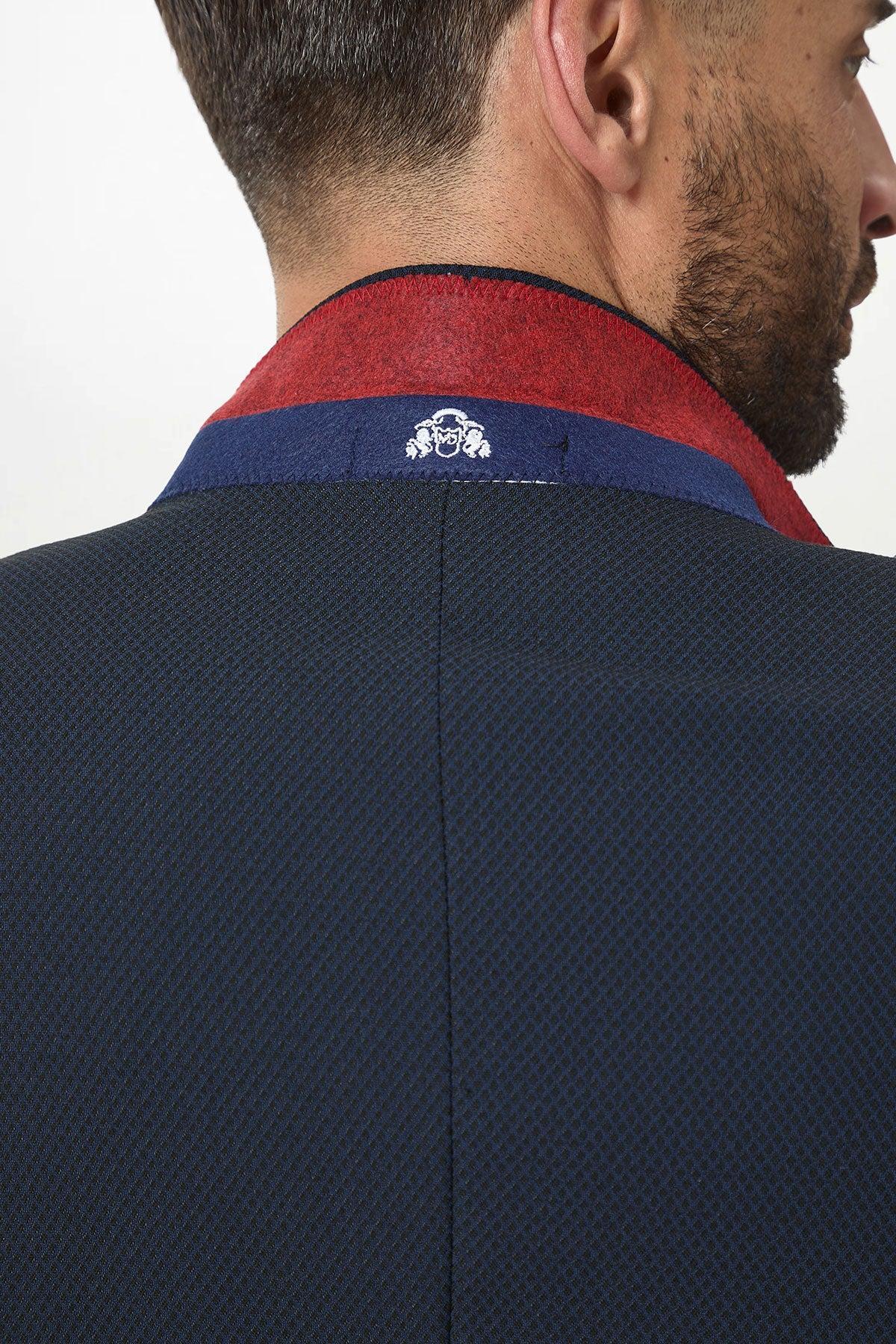 The marcdarcy MAX Navy Blue Blazer with Contrast Buttons features red and blue accents and a white embroidered crest on the band, making it perfect for office wear.