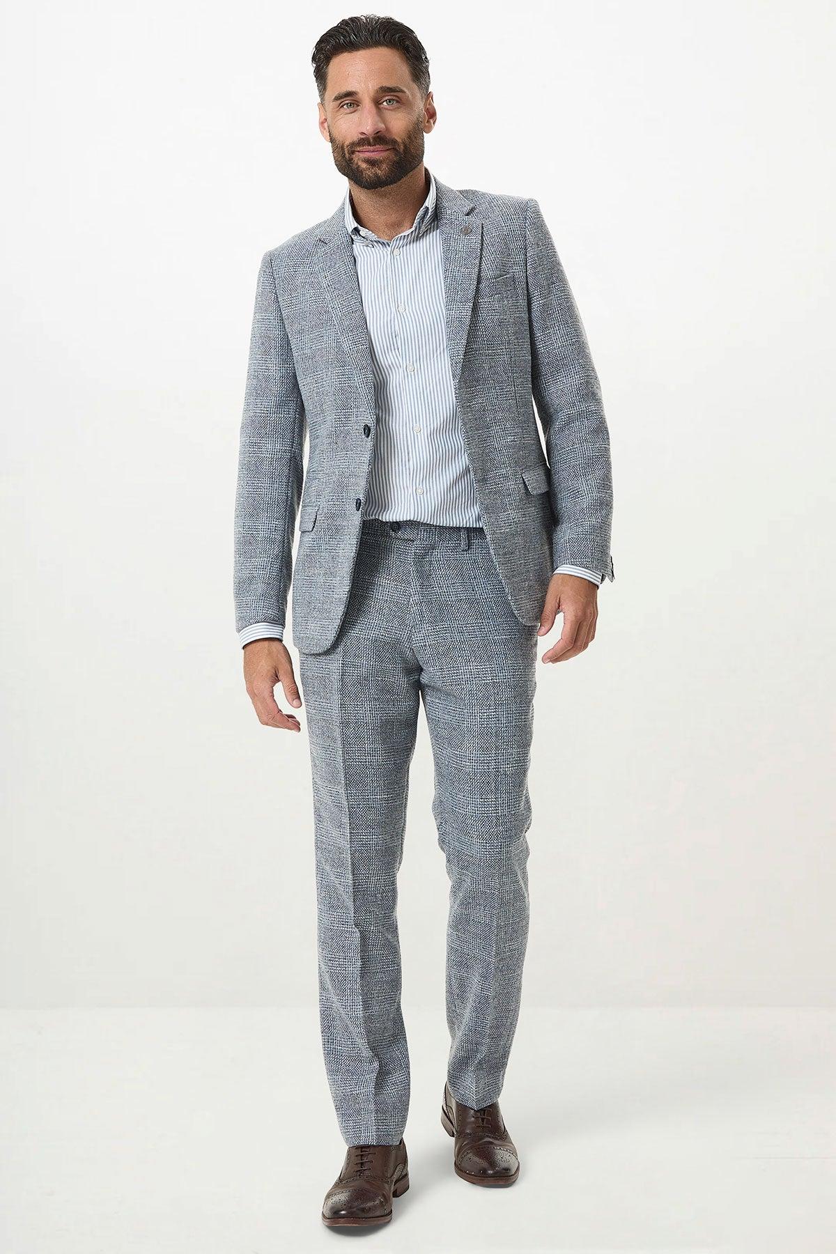 A man in the marcdarcy KRIS sky blue tweed two piece suit with a striped shirt.