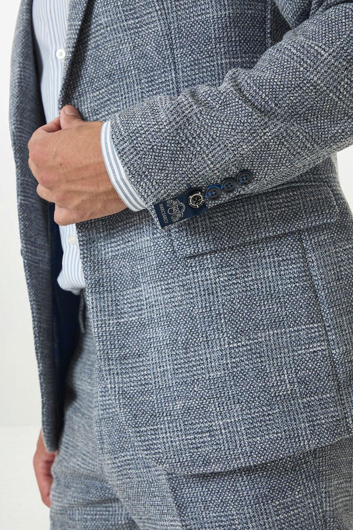 Close-up of a man in the marcdarcy KRIS Sky Blue Tweed Two Piece Suit, featuring navy buttons and a branded sleeve label, paired with a striped dress shirt peeking from the cuff.
