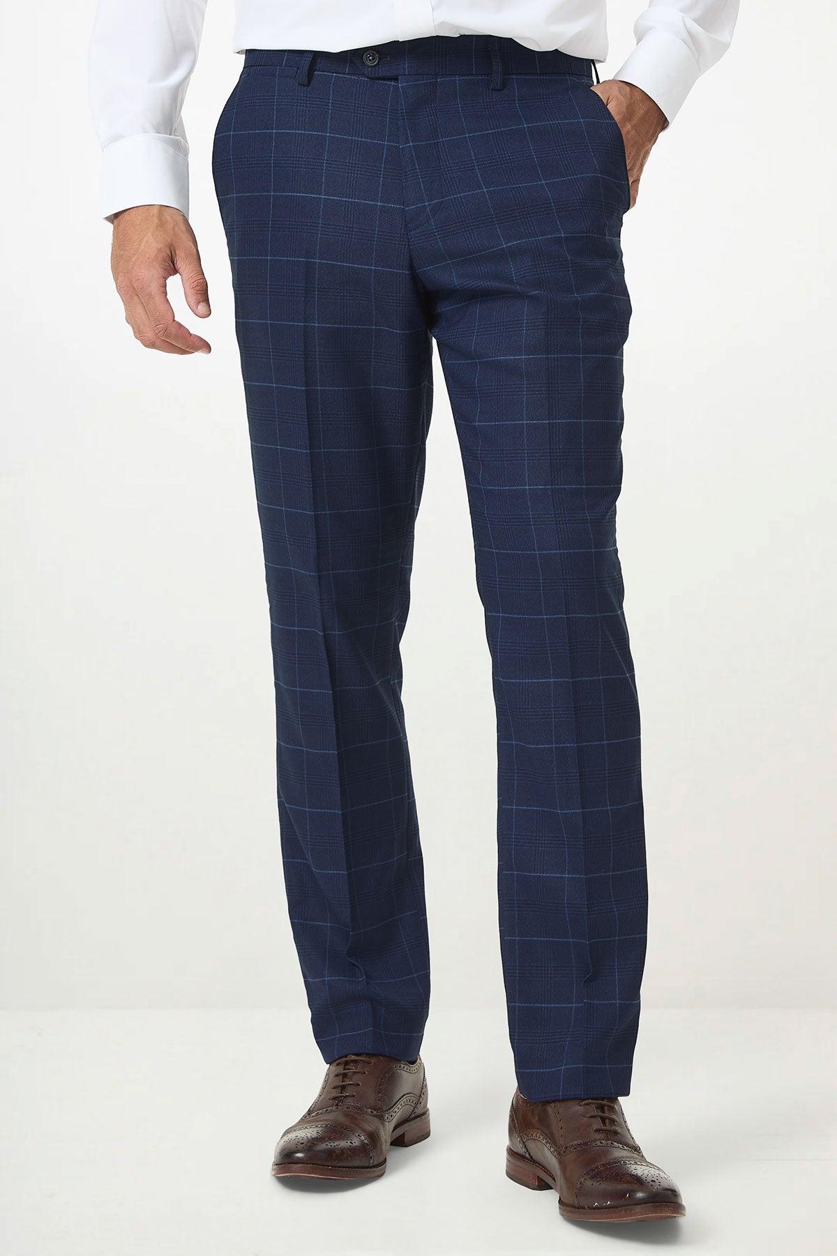 A man wears the Marc Darcy EDINSON - Navy Sky Check Trousers in a slim tailored fit, paired with brown dress shoes.