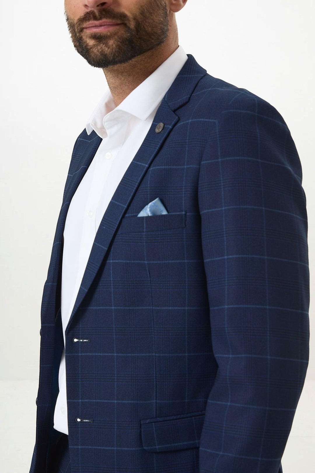 A man wears the Marc Darcy EDINSON Navy Sky Check Blazer in a slim fit, paired with a white shirt and light blue pocket square, shown from the chest up against a plain background.