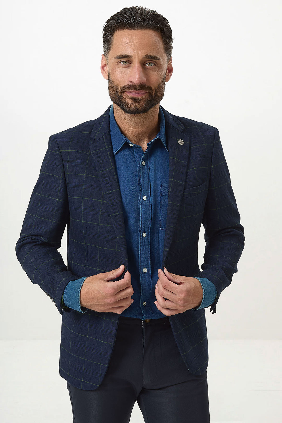 A man with dark hair and a beard models the Marc Darcy EDINSON Navy Green Check Blazer over a denim shirt, standing against a white background and looking confidently at the camera.