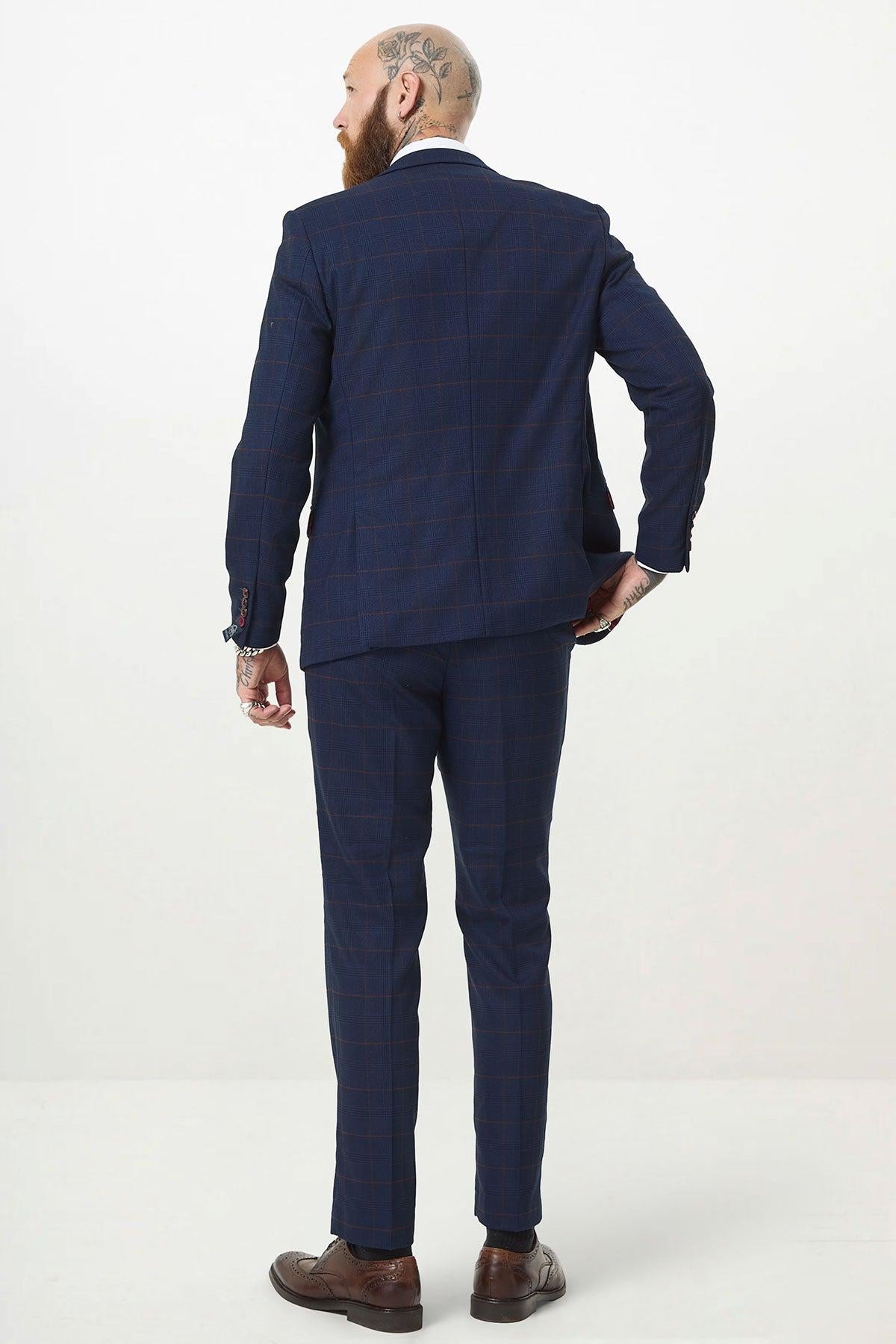 A man is shown from the back wearing the Marc Darcy EDINSON Navy Wine Check Three Piece Suit with brown dress shoes against a white background.