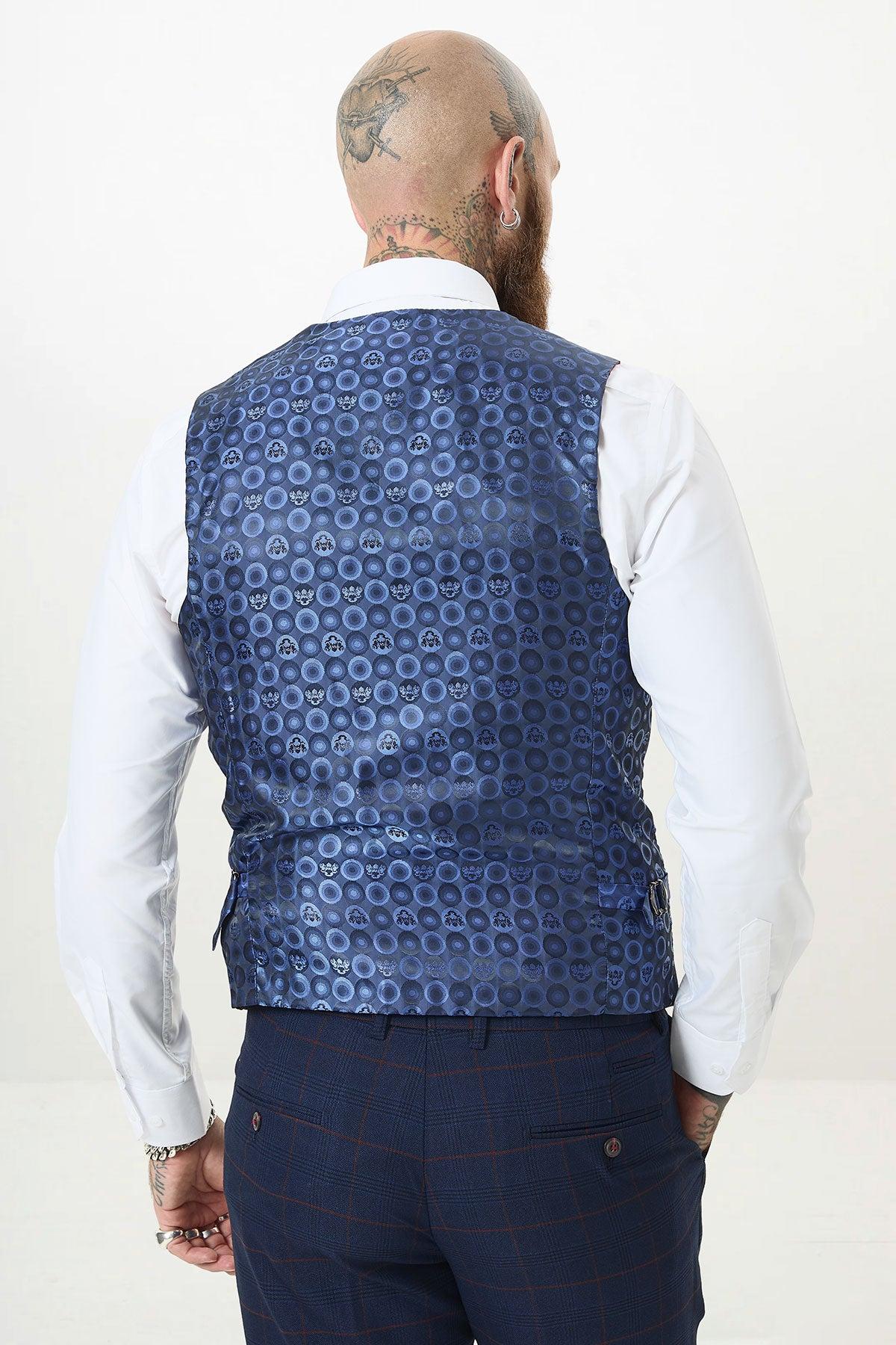 A bearded person with a bald head and tattoos, wearing a white shirt and a Marc Darcy EDINSON Navy Wine Check single-breasted waistcoat, is shown from the back.