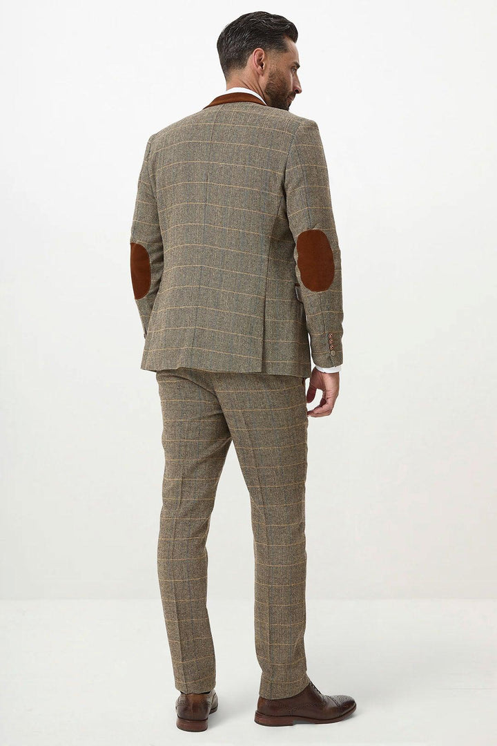 A man faces away, wearing the marcdarcy DX7 Tan Tweed Check Suit with Kelvin Cream Waistcoat and brown dress shoes, styled against a plain white background.