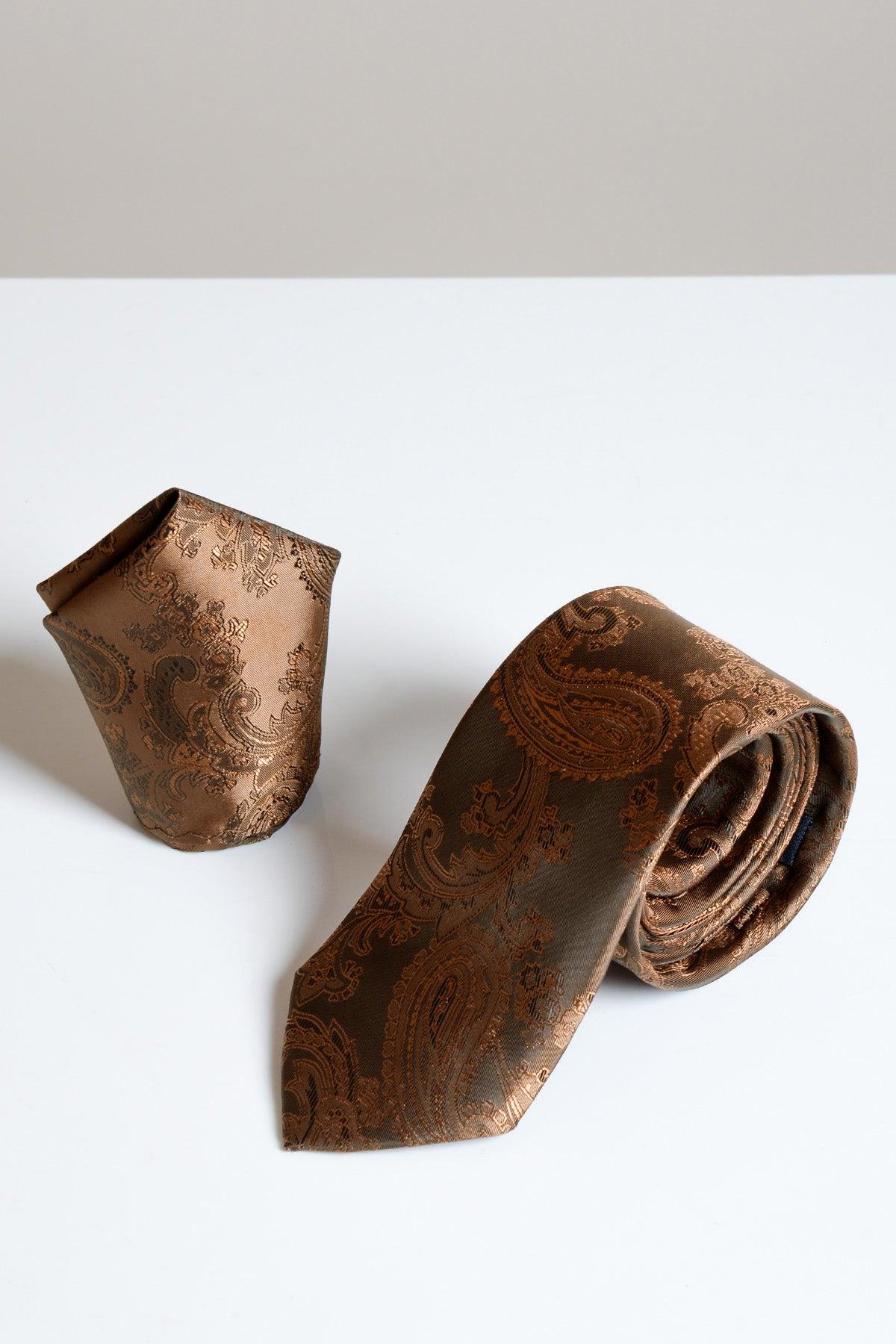 The Accessory MD PAISLEY Orange Brown Paisley Tie and Pocket Square Set rests elegantly on a white surface.