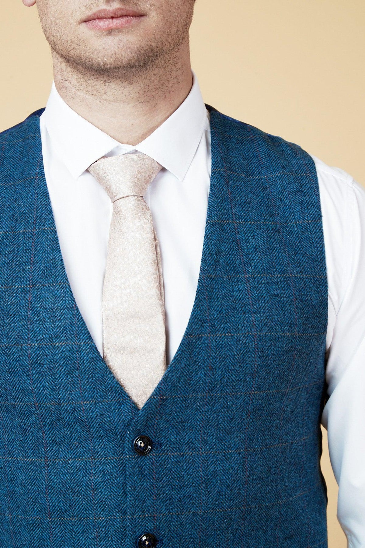 Close-up of a man in marcdarcy’s WHU Collection - TED Tan Tweed Suit with Dion Waistcoat as worn by Lukasz Fabianski, showcasing a classic English gent tweed style.