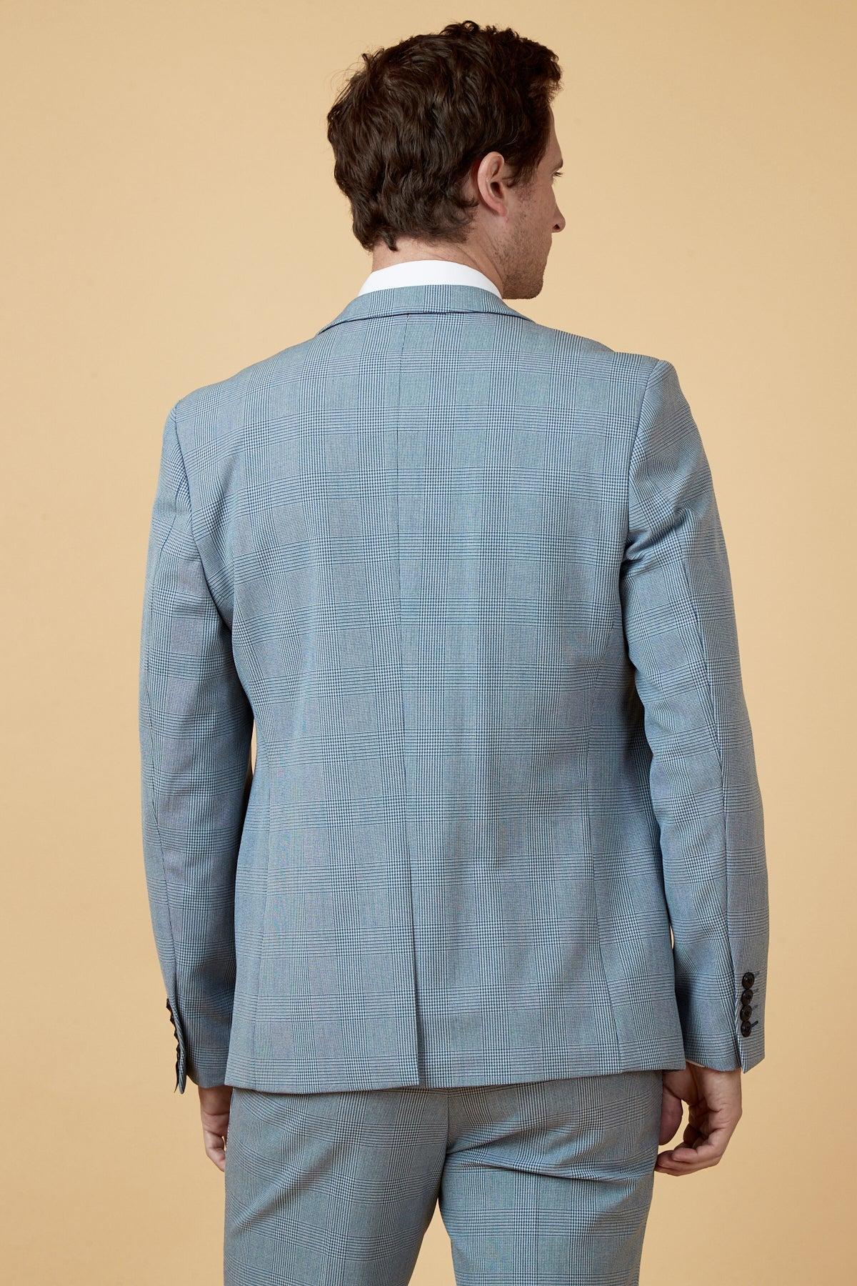 Calum Lill as Joel Deering on Coronation Street wears the Marc Darcy BROMLEY Sky Blue Blazer with wine chinos, viewed from the back.