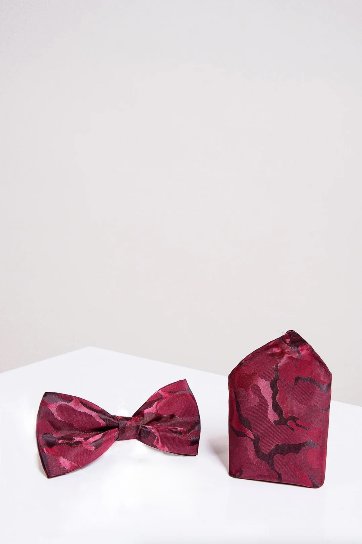 The BT ARMY - Wine Camouflage Bow Tie and Pocket Square Set by Accessory is displayed on a white surface.