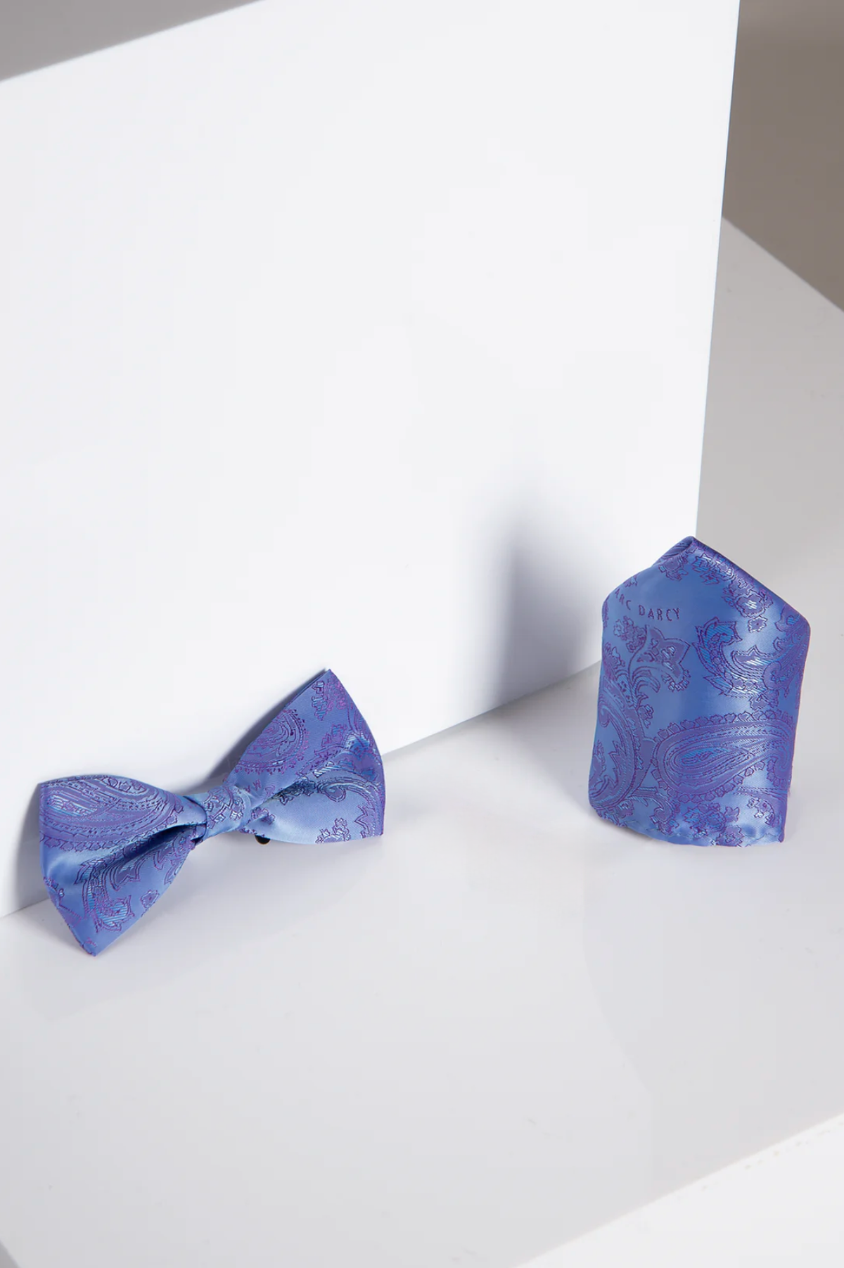 The Accessory MD PAISLEY - Lilac Paisley Bow Tie and Pocket Square Set is displayed on a white surface.