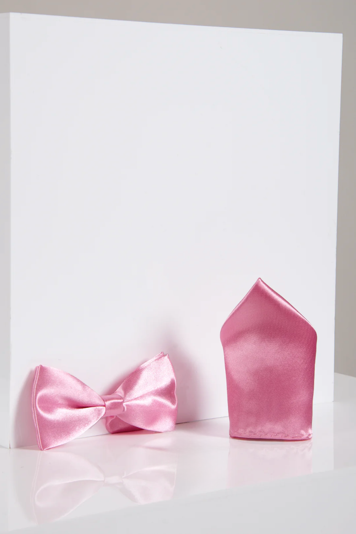 The Accessory SB - Satin Bow Tie and Pocket Square Set in Pink is shown upright and side by side against a plain white background, perfect for formal wear.