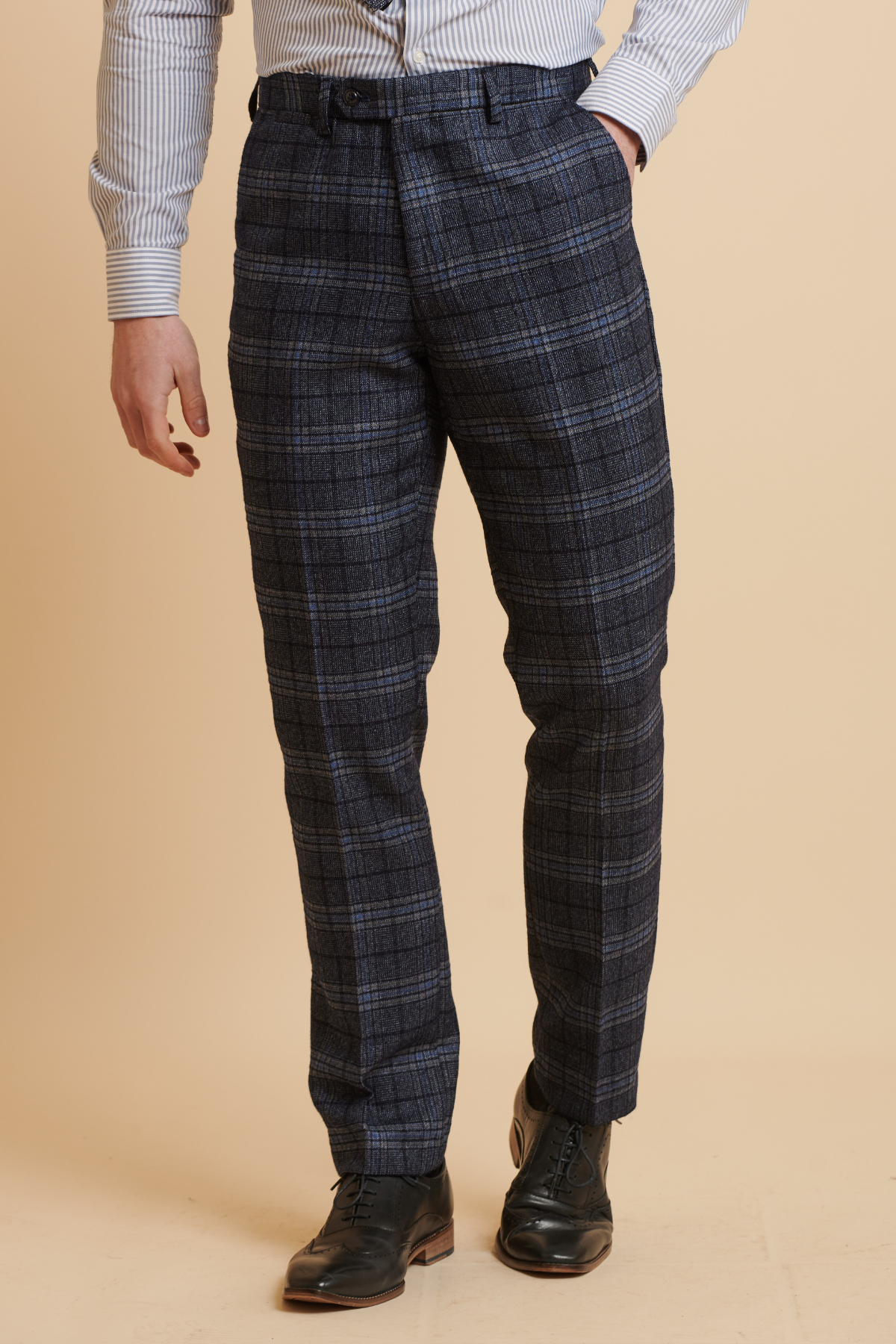 A man wears slim fit Marc Darcy ANDY - Blue Check Trousers with a hand in his pocket, paired with a pinstripe shirt.
