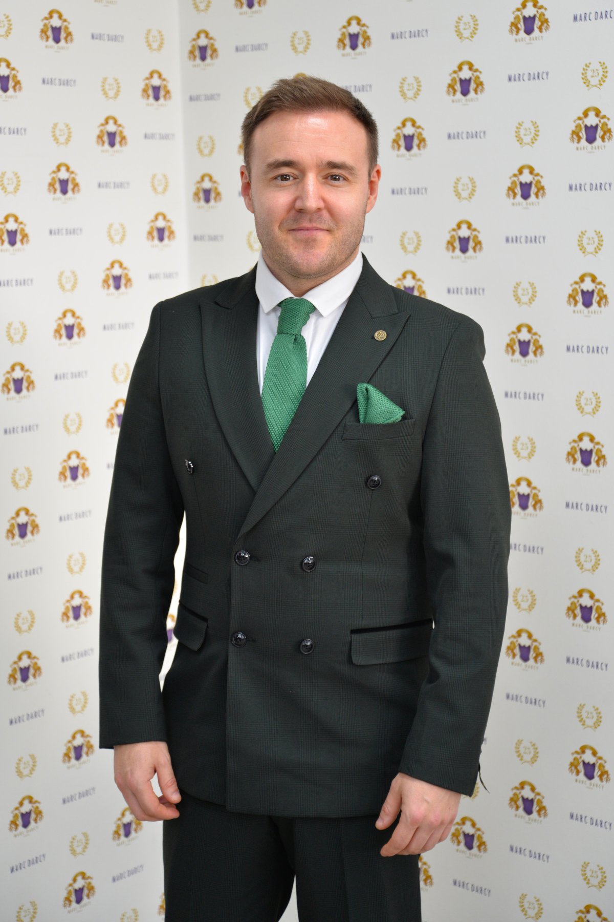 Coronation Street’s Alan Halsall (Tyrone Dobbs) smiles in the Marc Darcy BROMLEY Olive Green Double Breasted Suit, styled with a green tie and pocket square.