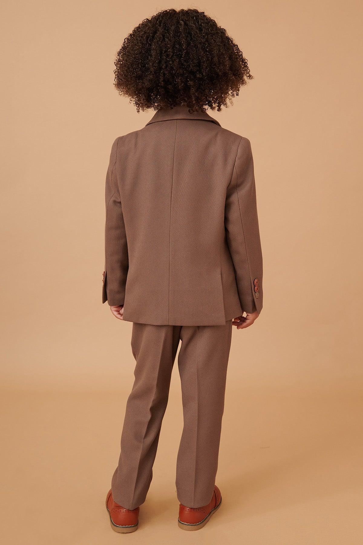 Back view of a child in the Marc Darcy HM5 Children's Tan Tailored Three Piece Suit with brown shoes, ideal as a formal outfit for weddings.
