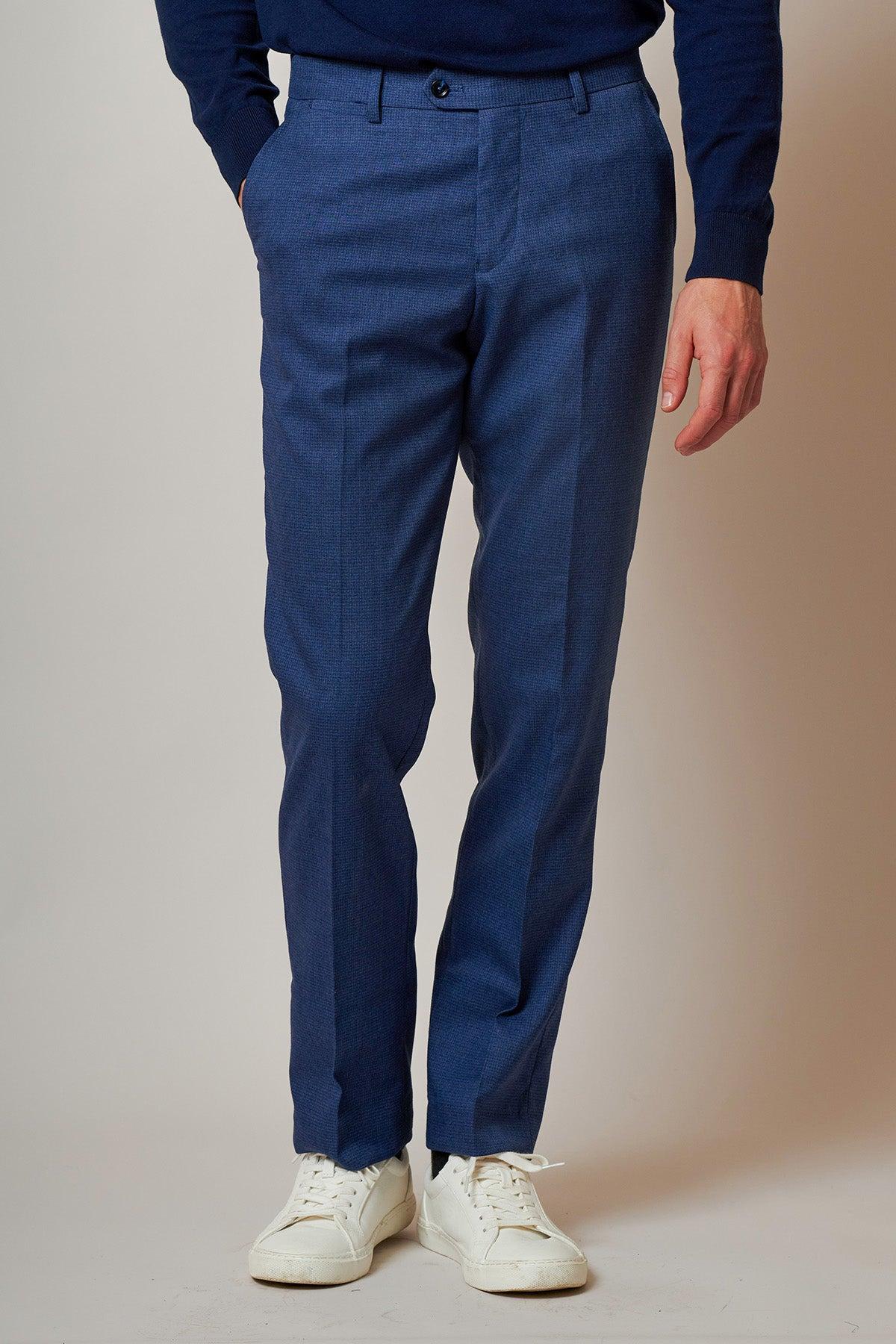 A person wears the Marc Darcy ASHLEY Navy Blue Two Piece Suit with white sneakers against a light gray background.