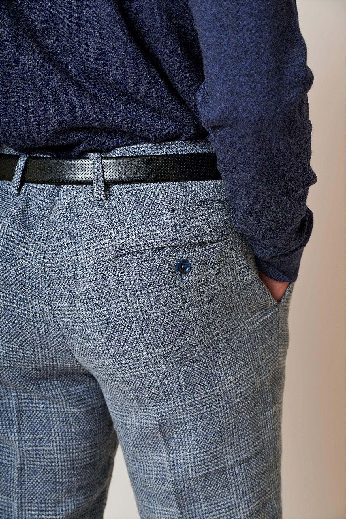 Close-up shot of a person wearing the marcdarcy Everton Collection KRIS Sky Blue Tweed Suit, styled with a black belt and hand in pocket for a refined, modern look.