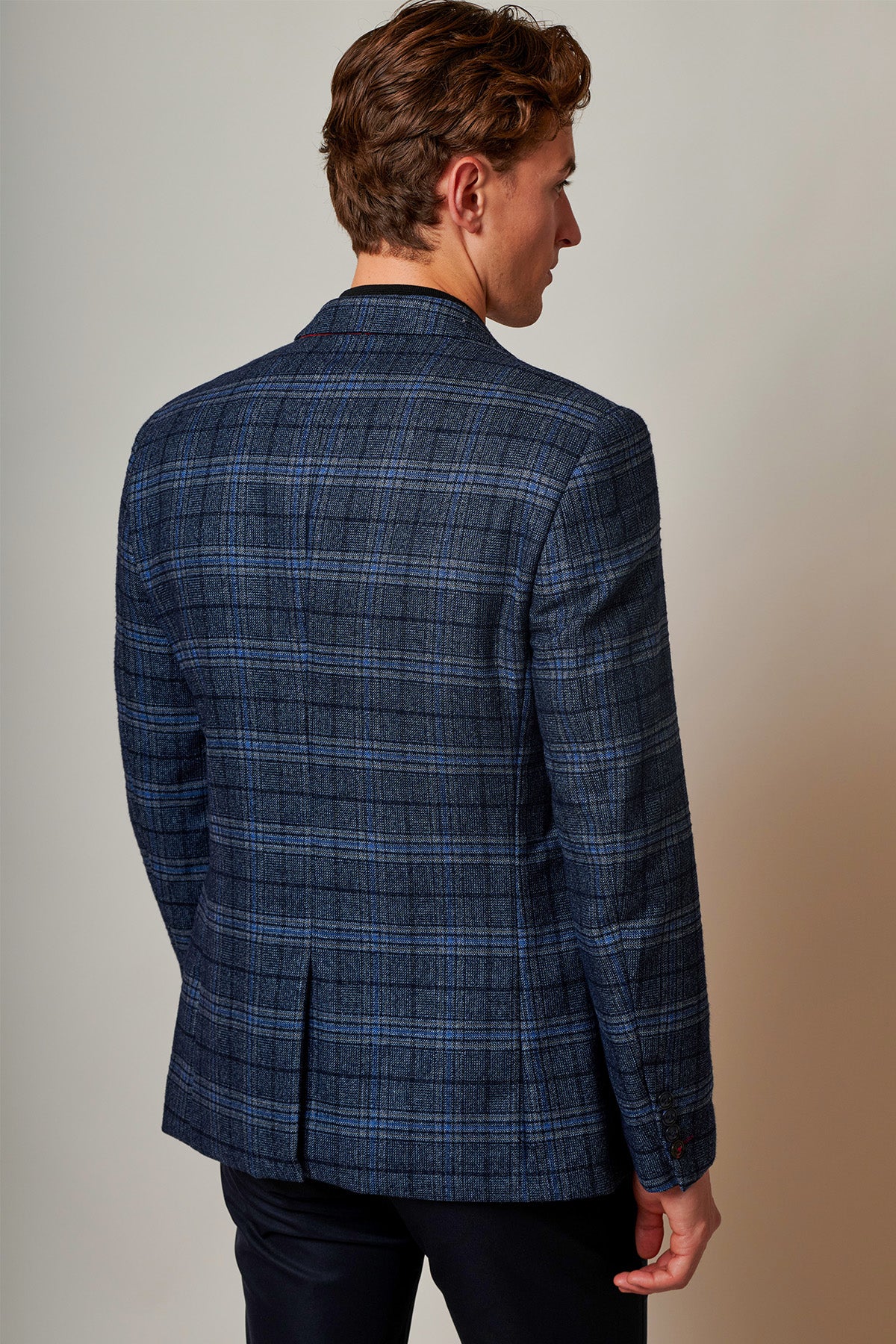 Back view of a man wearing the Marc Darcy ANDY Blue Check Two Piece Suit, highlighting the modern elegance of its slim fit design.