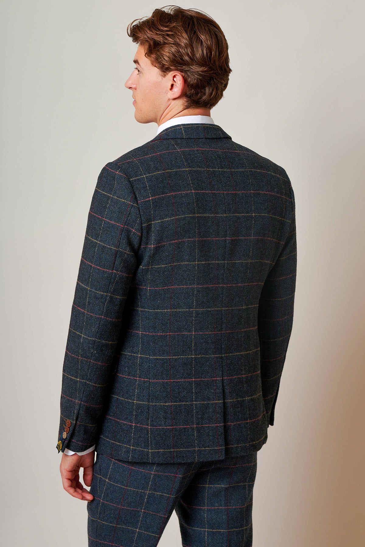 Back view of a man with short, curly brown hair wearing the marcdarcy ETON - Navy Blue Tweed Check Blazer.