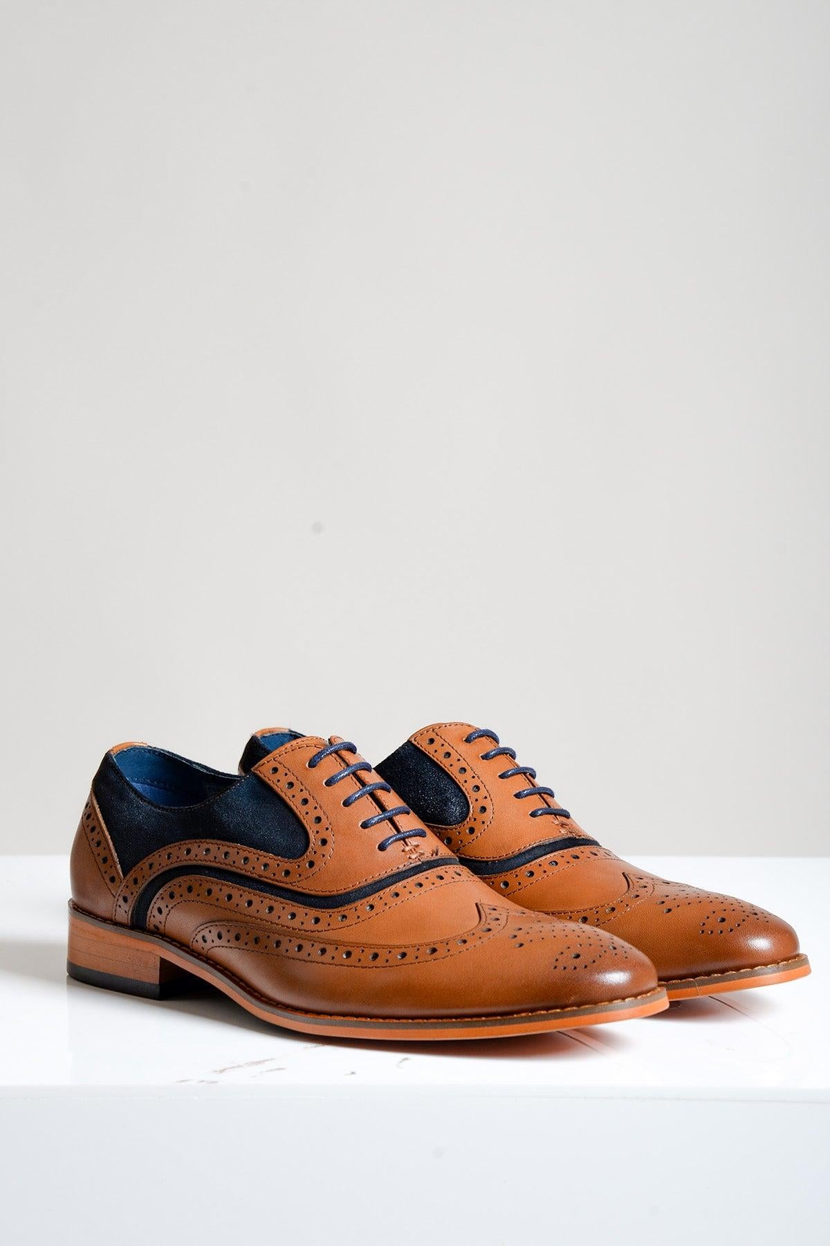 A pair of MURRAY - Contrast Tan Leather Suede Brogue Shoes by Marc Darcy, featuring decorative perforations, displayed on a white surface with a light gray background.