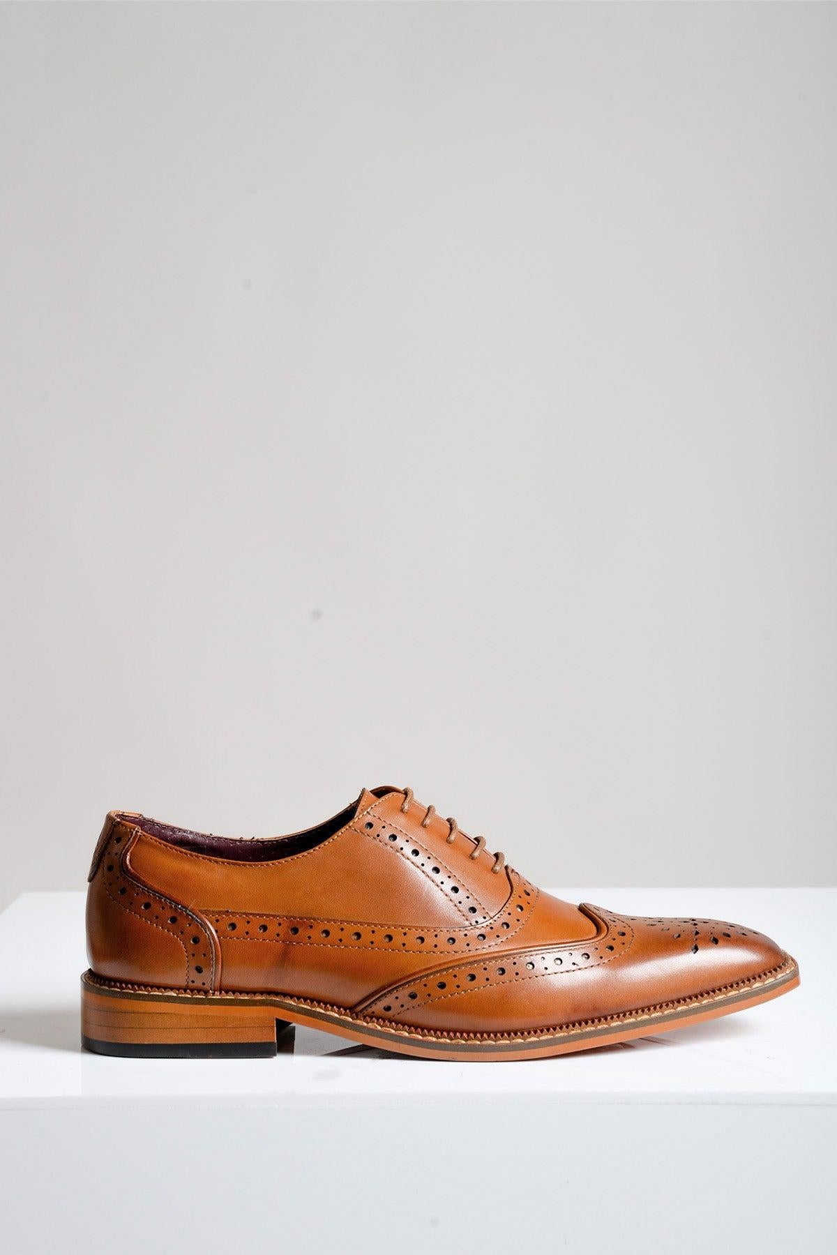 The LARKIN - Tan Leather Brogue Shoe by Marc Darcy features full grain leather, decorative perforations, and laces, shown on a white surface with a light gray background.