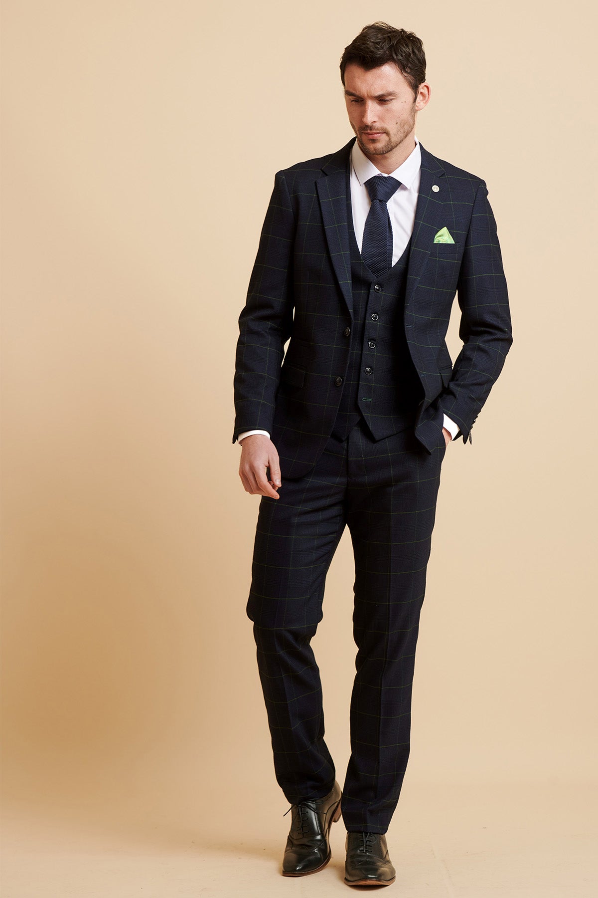 James Tarkowski models the Marc Darcy Everton Collection EDINSON Navy Green Check Suit, styled with a white shirt, navy tie, and green pocket square.