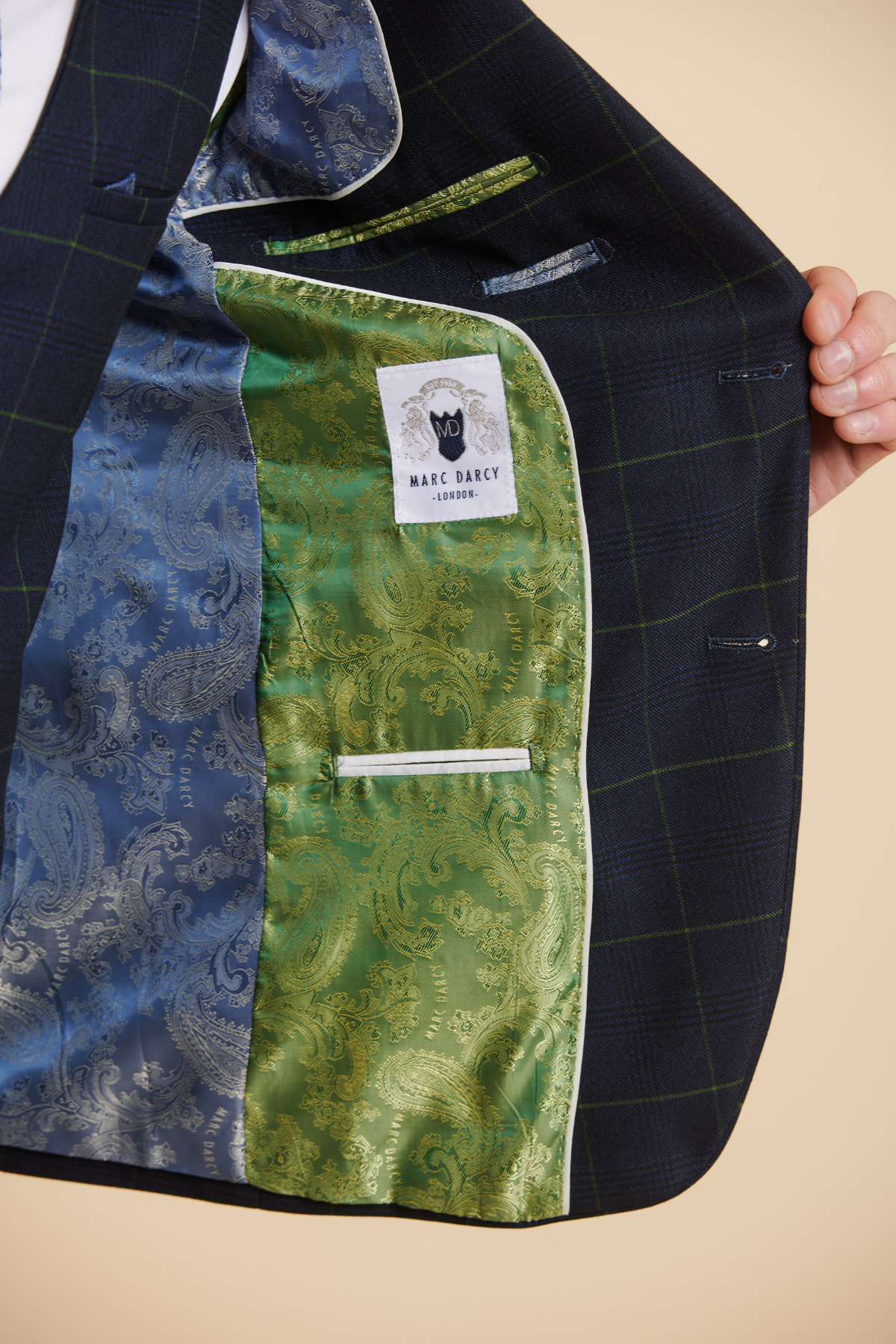 Close-up of the inside of The Everton Collection | James Tarkowski In EDINSON Navy Green Check Suit by Marc Darcy, featuring a green paisley lining, blue paisley detail, and bespoke slim tailored fit.