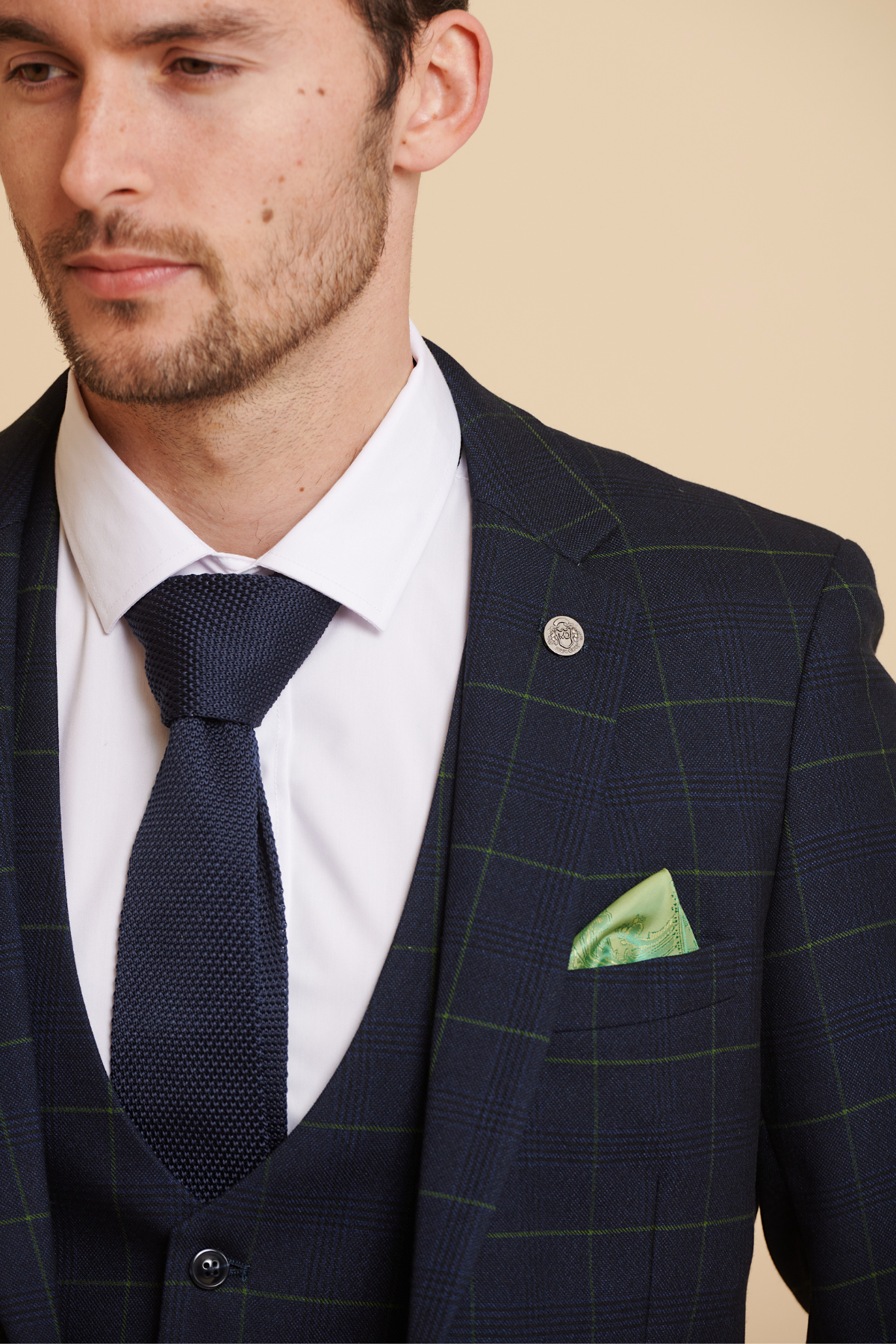 James Tarkowski wears the Marc Darcy Everton Collection EDINSON Navy Green Check Suit, styled with a navy knit tie, white shirt, green pocket square, and lapel pin.