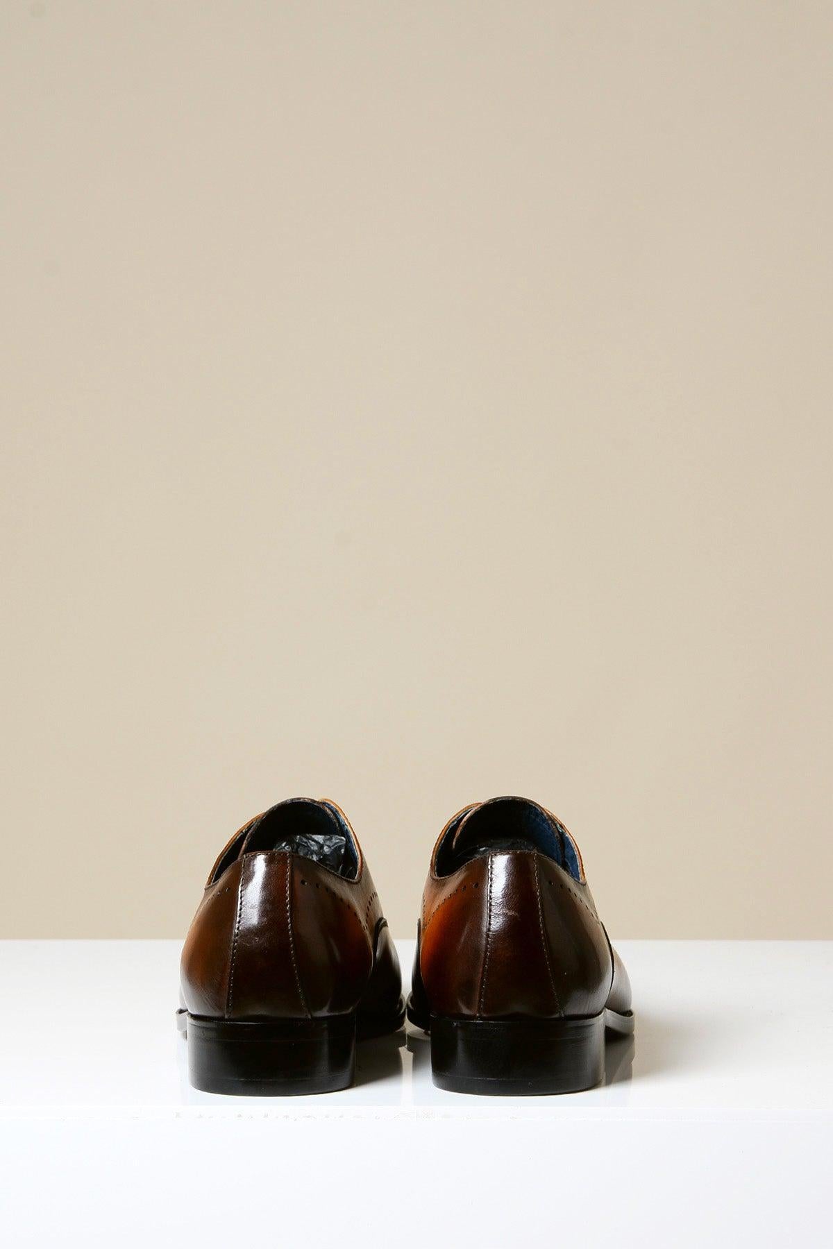 The JAKE Tan Leather Contrast Oxford Shoes by Marc Darcy are shown side by side on a white surface, facing away from the camera, set against a plain beige background.