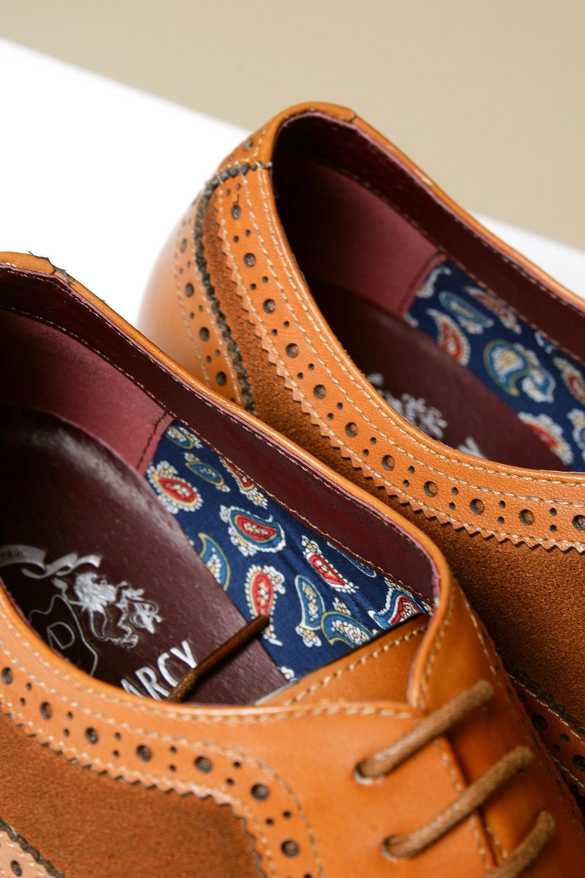 Close-up of Marc Darcy's BRADLEY tan leather suede contrast brogue shoes, featuring classic brogue detailing, a navy paisley lining, and "ARCY" visible on the insole.