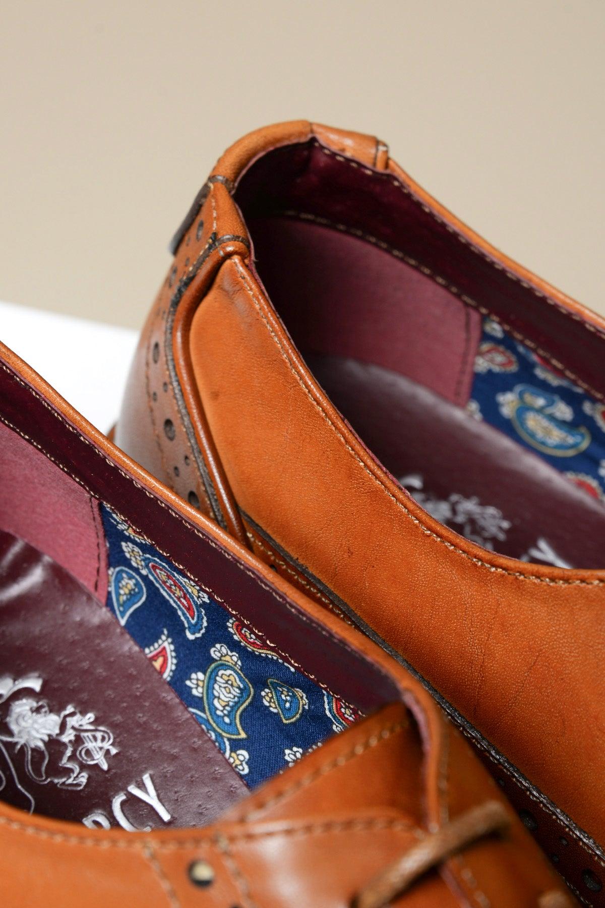 Close-up of the Marc Darcy LARKIN tan leather brogue shoe, showing a burgundy lining, blue paisley fabric tongue detail, and branded insole label.