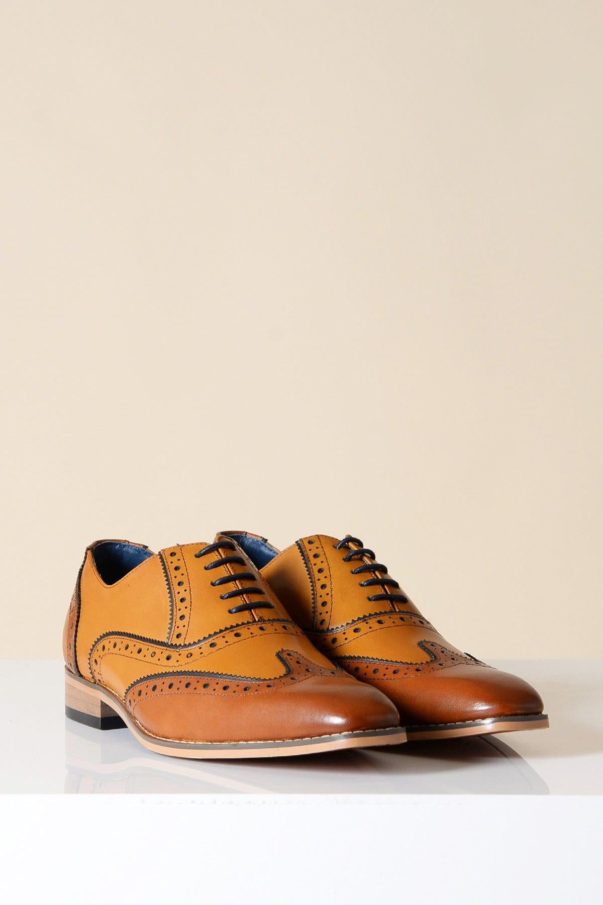 The MARCO - Tan Leather Oxford Wingtip Shoe by Marc Darcy features full grain leather in tan and brown, dark laces, and hand-stitched details, displayed on a white surface with a plain beige background.