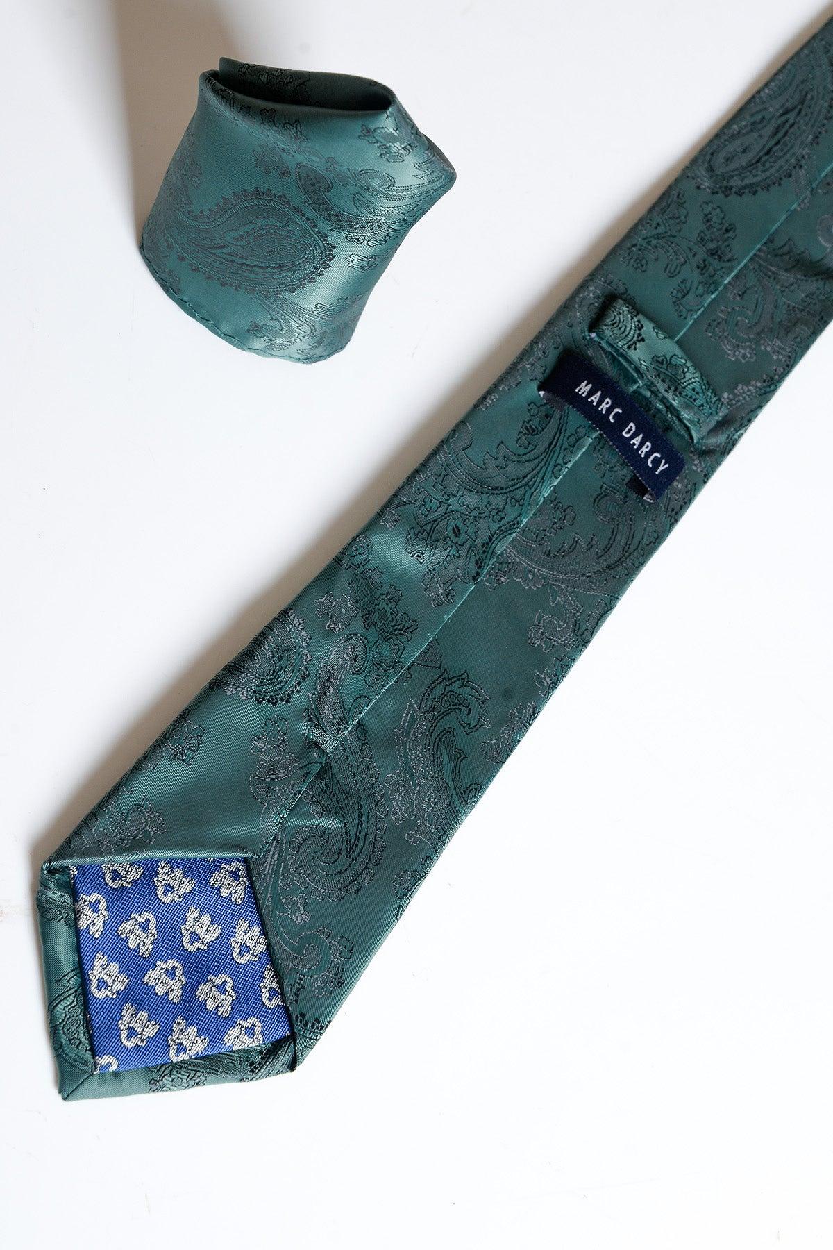 The MD PAISLEY - Bottle Green Paisley Tie and Pocket Square Set by Accessory is displayed on a white surface, featuring a striking paisley design, blue floral lining on the tie’s back, and the signature Accessory brand label.