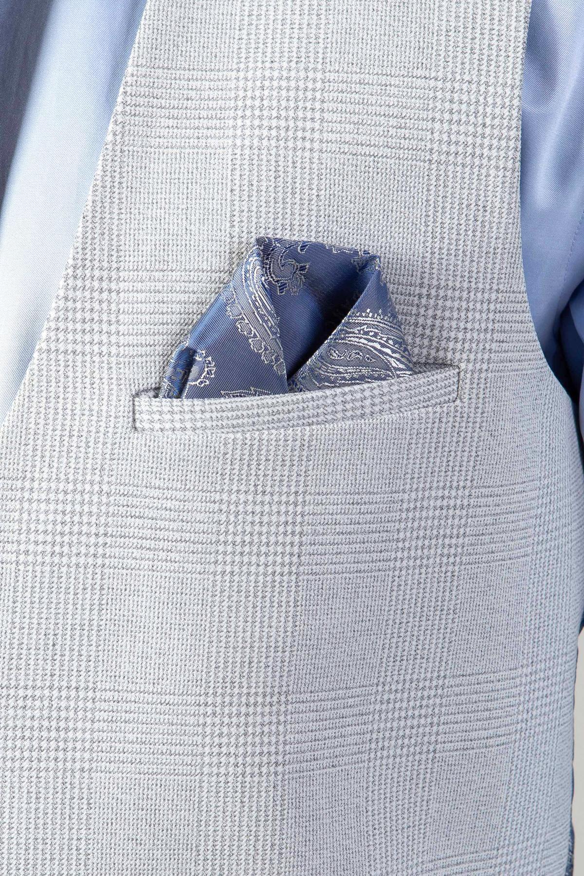A close-up of the Marc Darcy WBA Collection - BROMLEY Stone Suit waistcoat in light gray Prince of Wales check, styled with a blue paisley pocket square and worn over a light blue shirt.