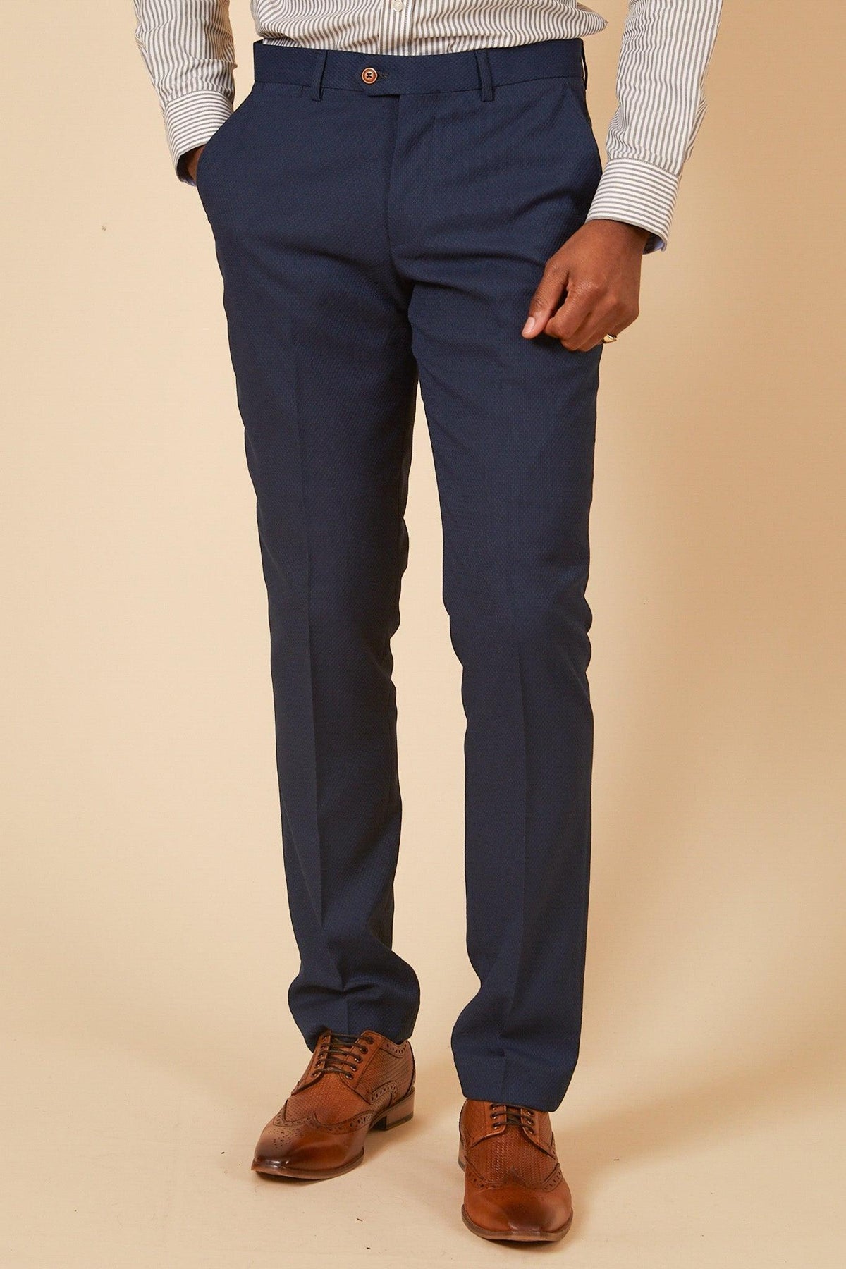 A man wearing the marcdarcy Official Leicester City F.C. Club Suit—a MAX Royal Blue Suit with Kelvin Tan Waistcoat—poses with his hand in his pocket.