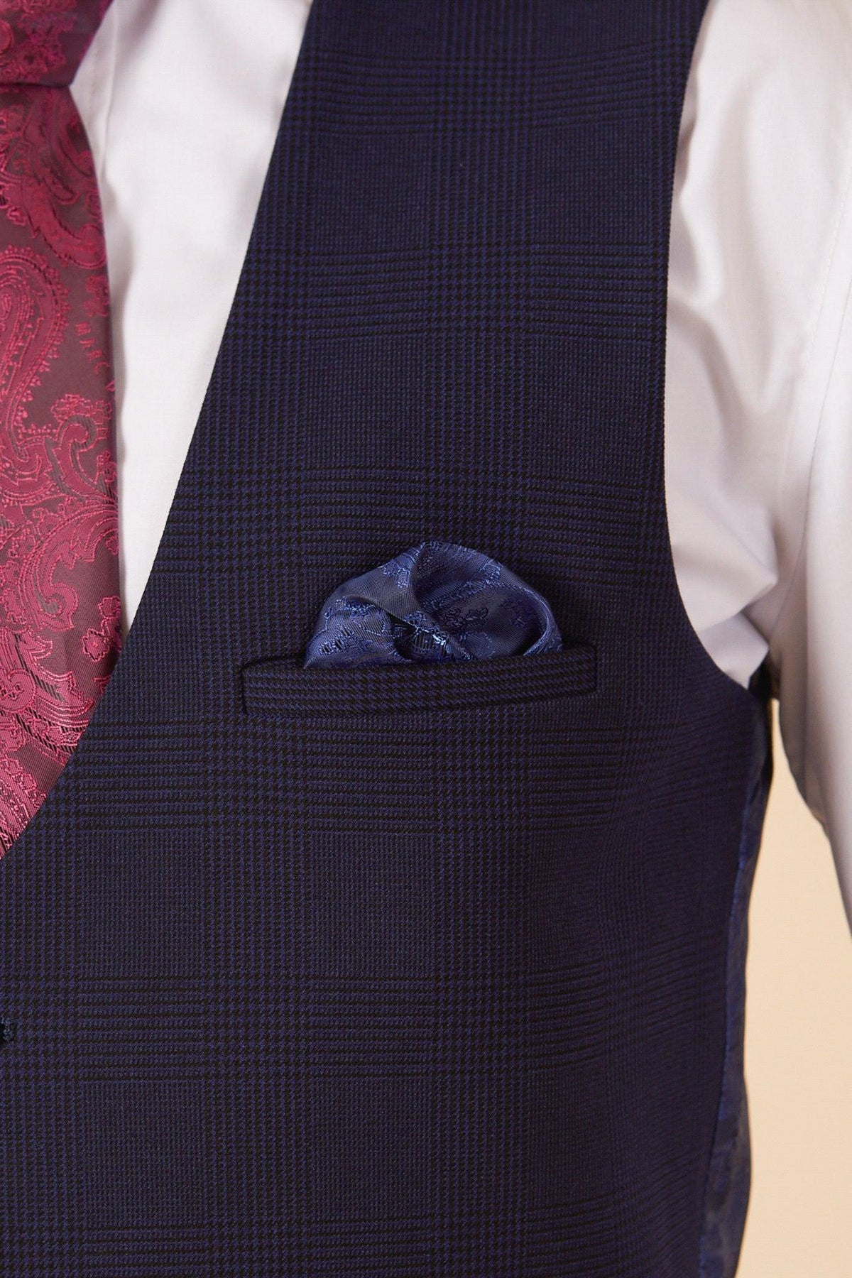 A close-up of a person wearing the Marc Darcy West Ham United Footballer Jarrod Bowen in Bromley Navy Check Suit with a matching blue pocket square and patterned burgundy tie.