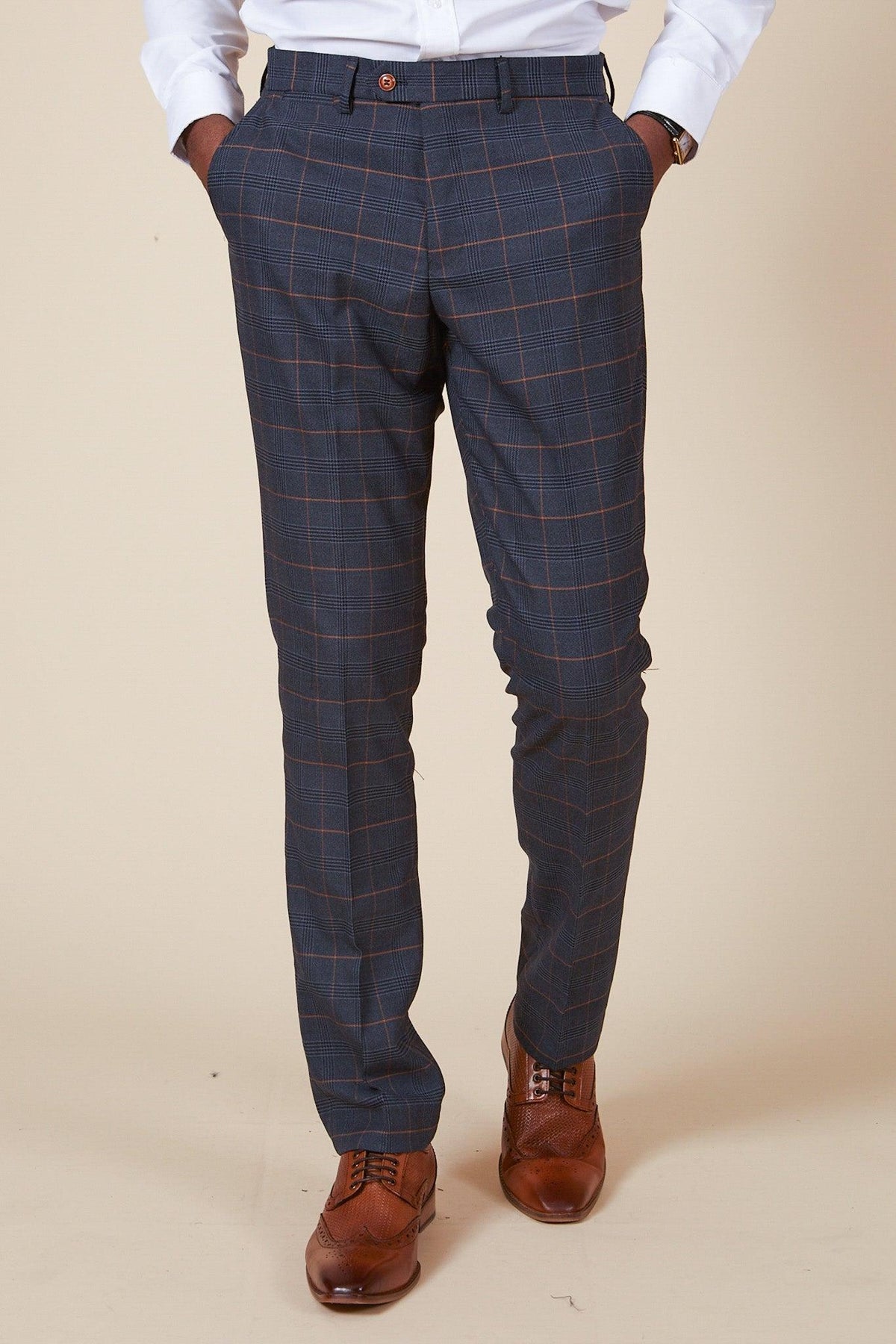 A man wears the marcdarcy WBA Collection Jenson Marine Suit with a Kelvin Tan Waistcoat, as worn by John Swift.