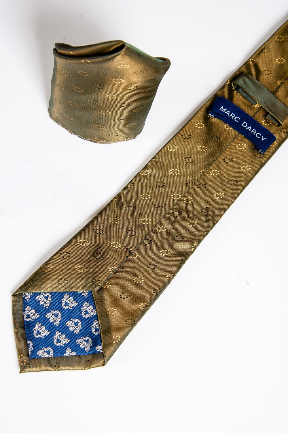 The TS CIRCLE Gold Circle Tie and Pocket Square Set by Accessory features a handmade gold tie with small circle patterns, blue floral lining with Marc Darcy label, and a matching gold pocket square, elegantly displayed on a white background.